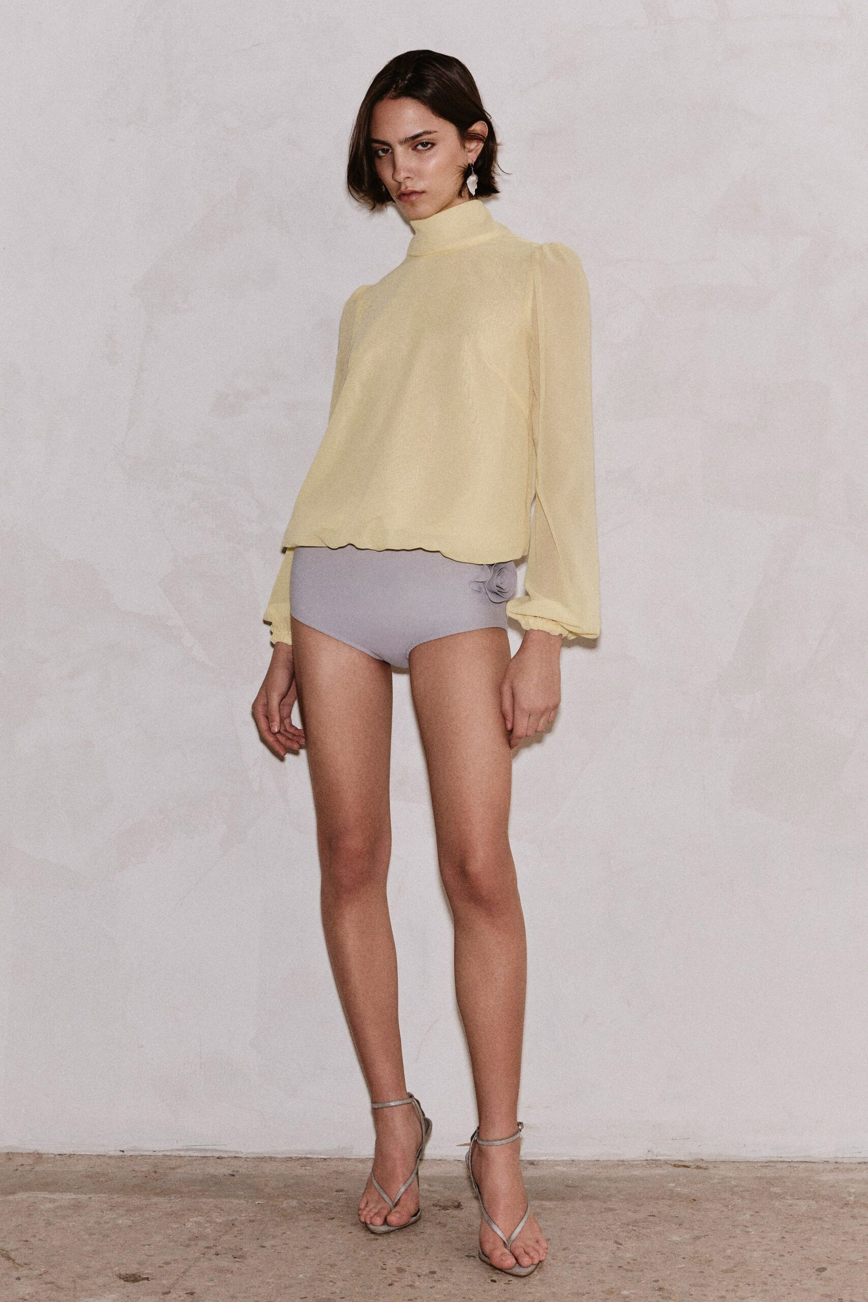 yellow chiffon top with gray shorts