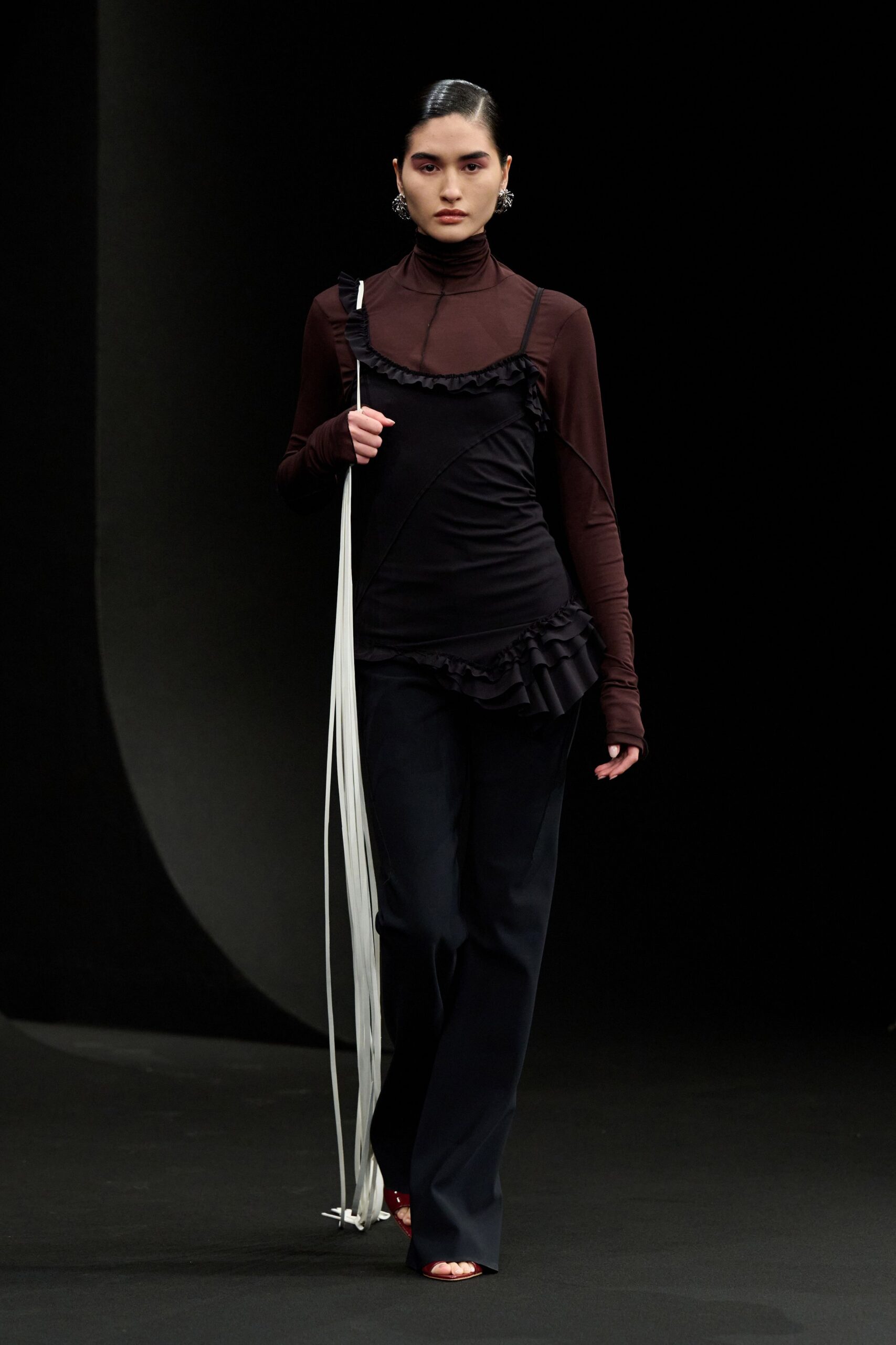 black and brown fitted top with tailored pants