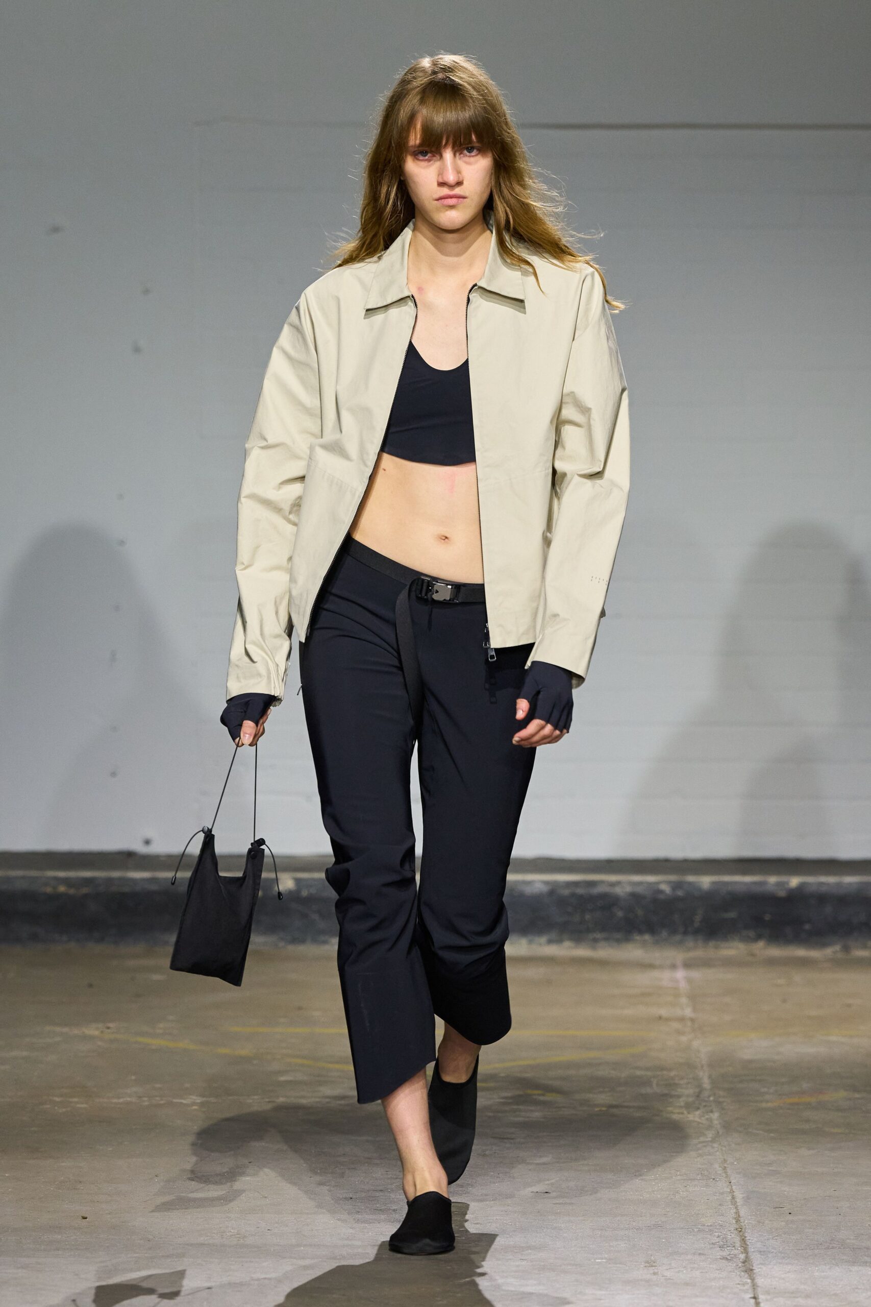 beige jacket black top pants