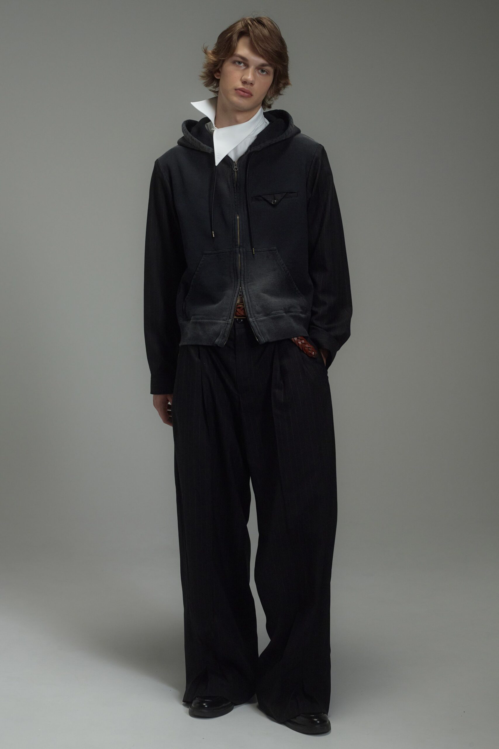 black hoodie with white shirt and relaxed pants