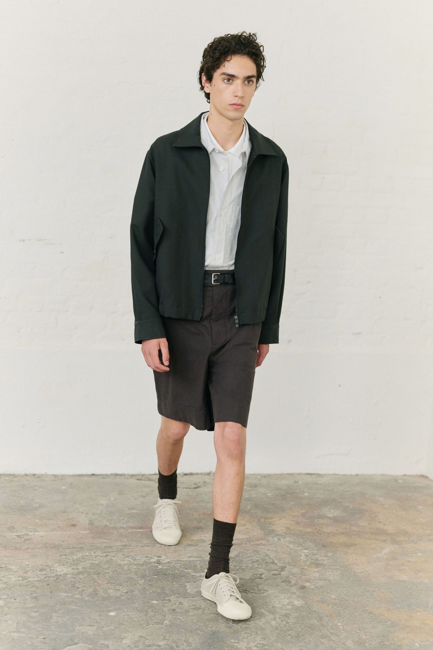 black jacket white shirt brown shorts