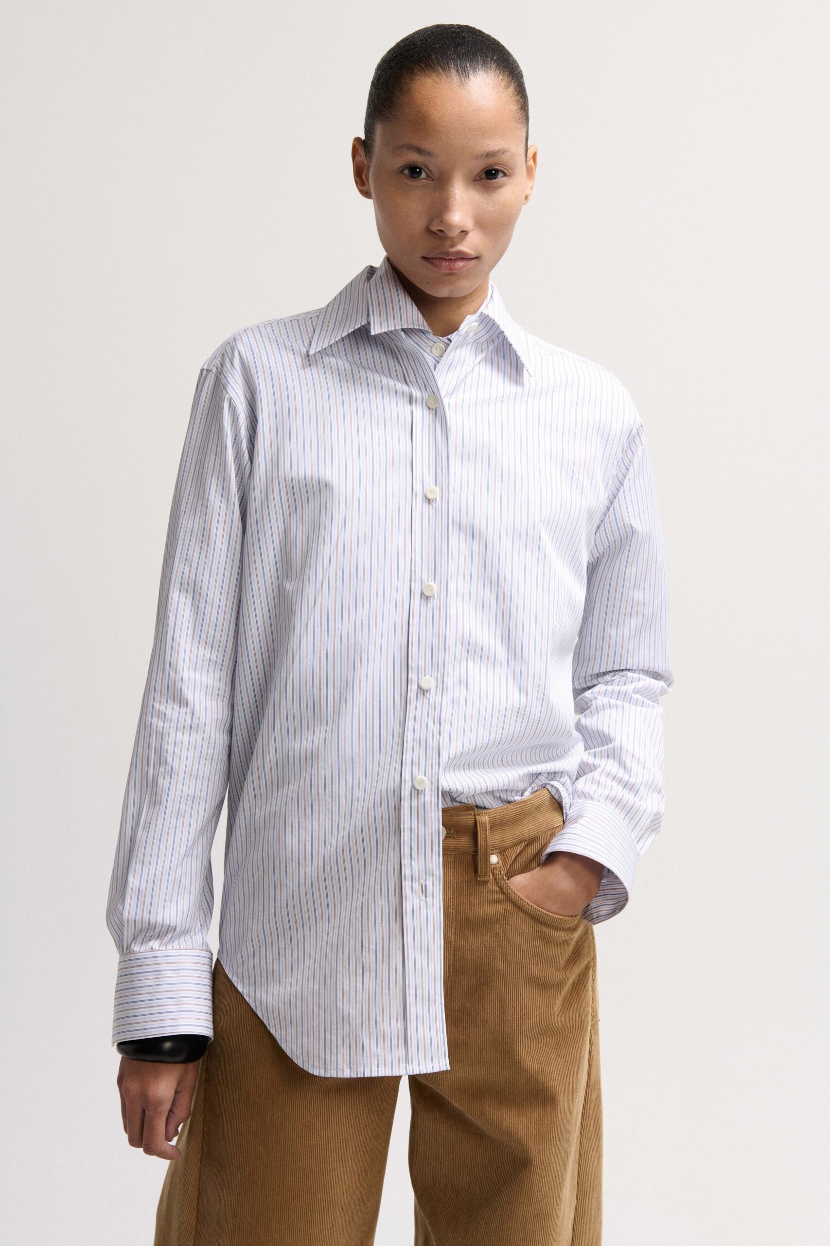 striped shirt and brown pants