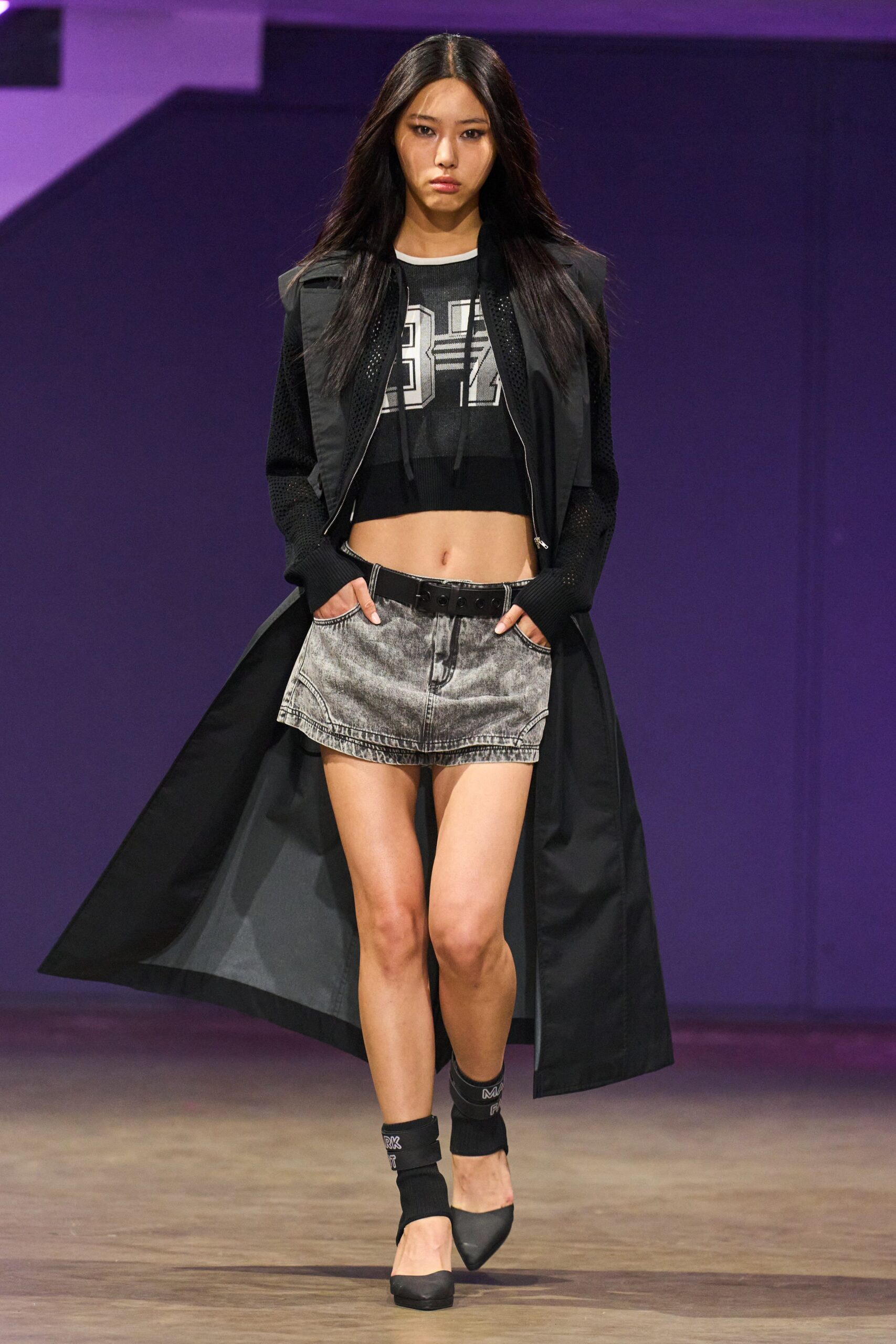 black coat with crop top and mini skirt