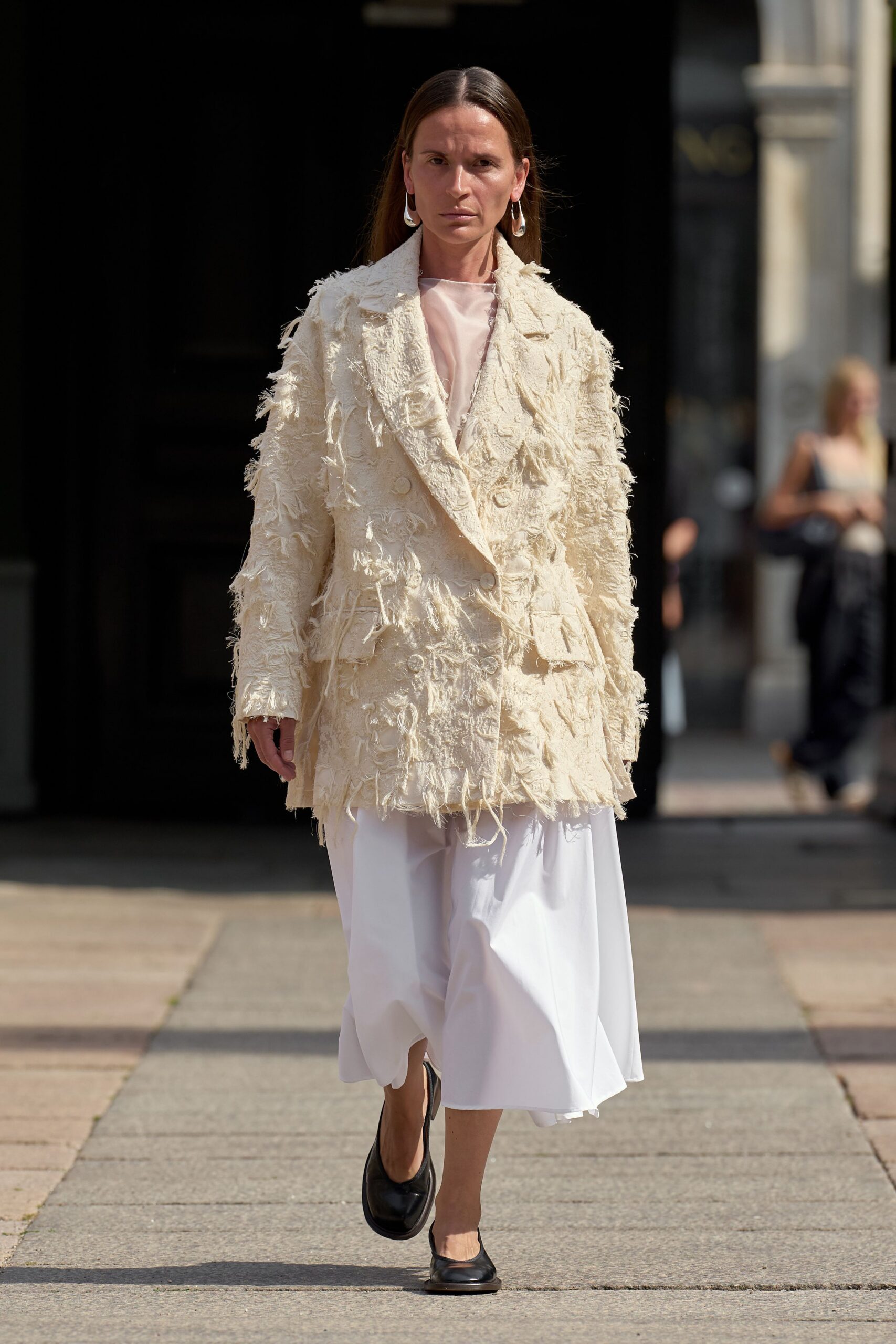beige fringed jacket white skirt