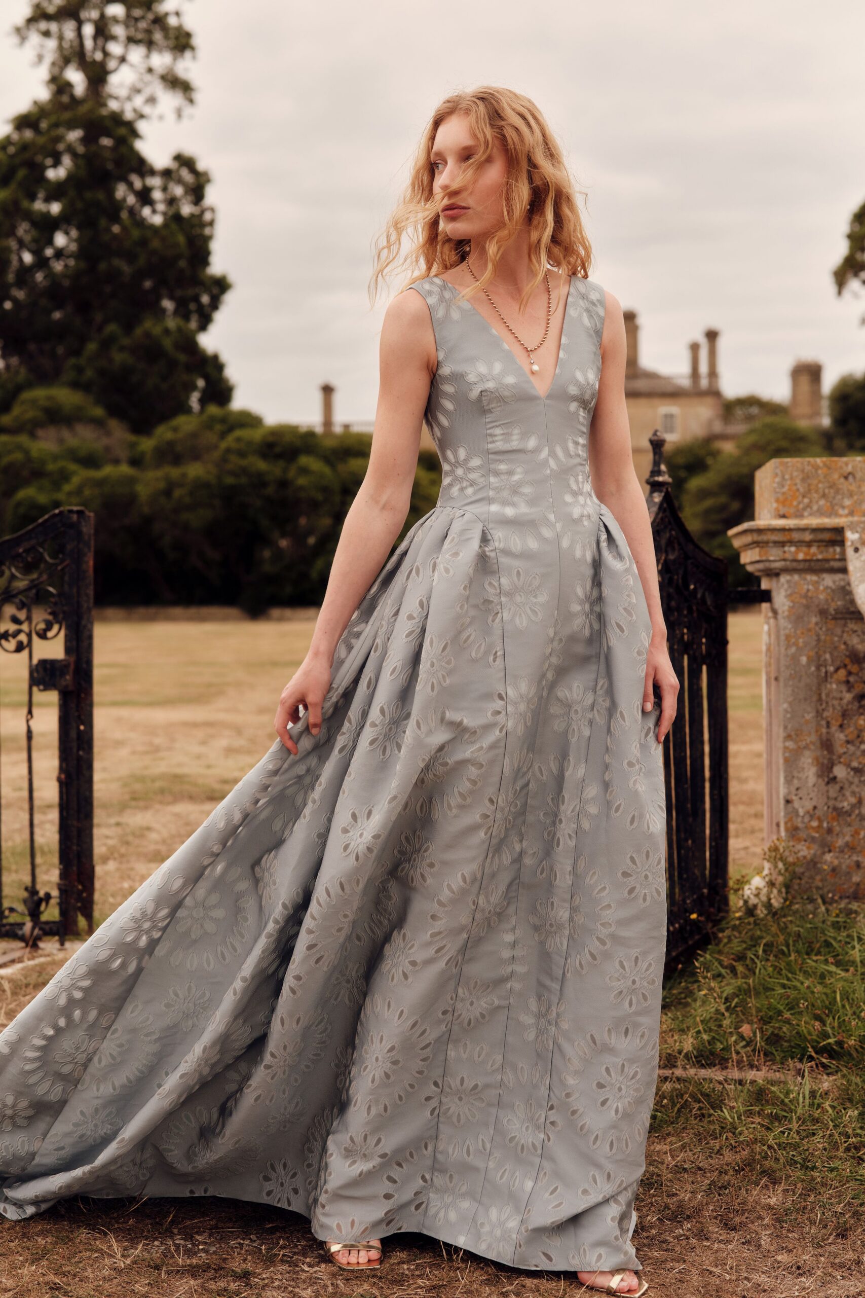 gray silk sleeveless v-neck fitted embroidered flowing gown