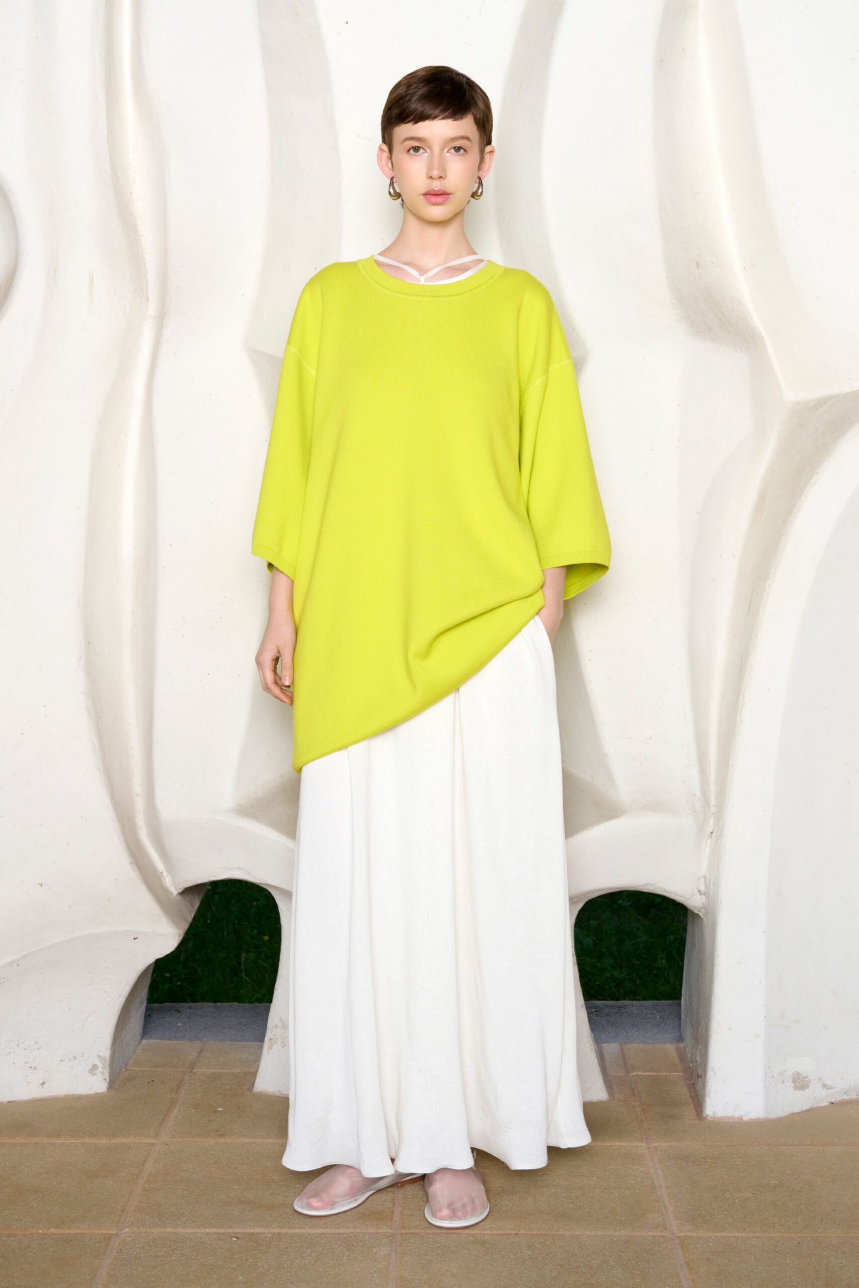green oversized top with white skirt