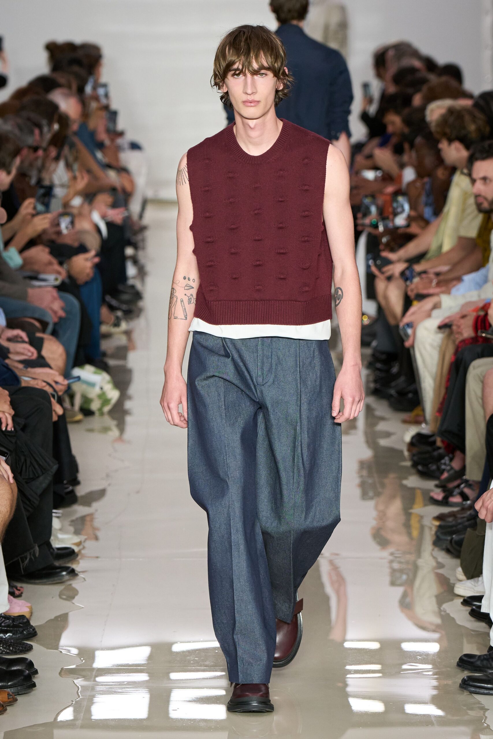 maroon sleeveless sweater with relaxed pants
