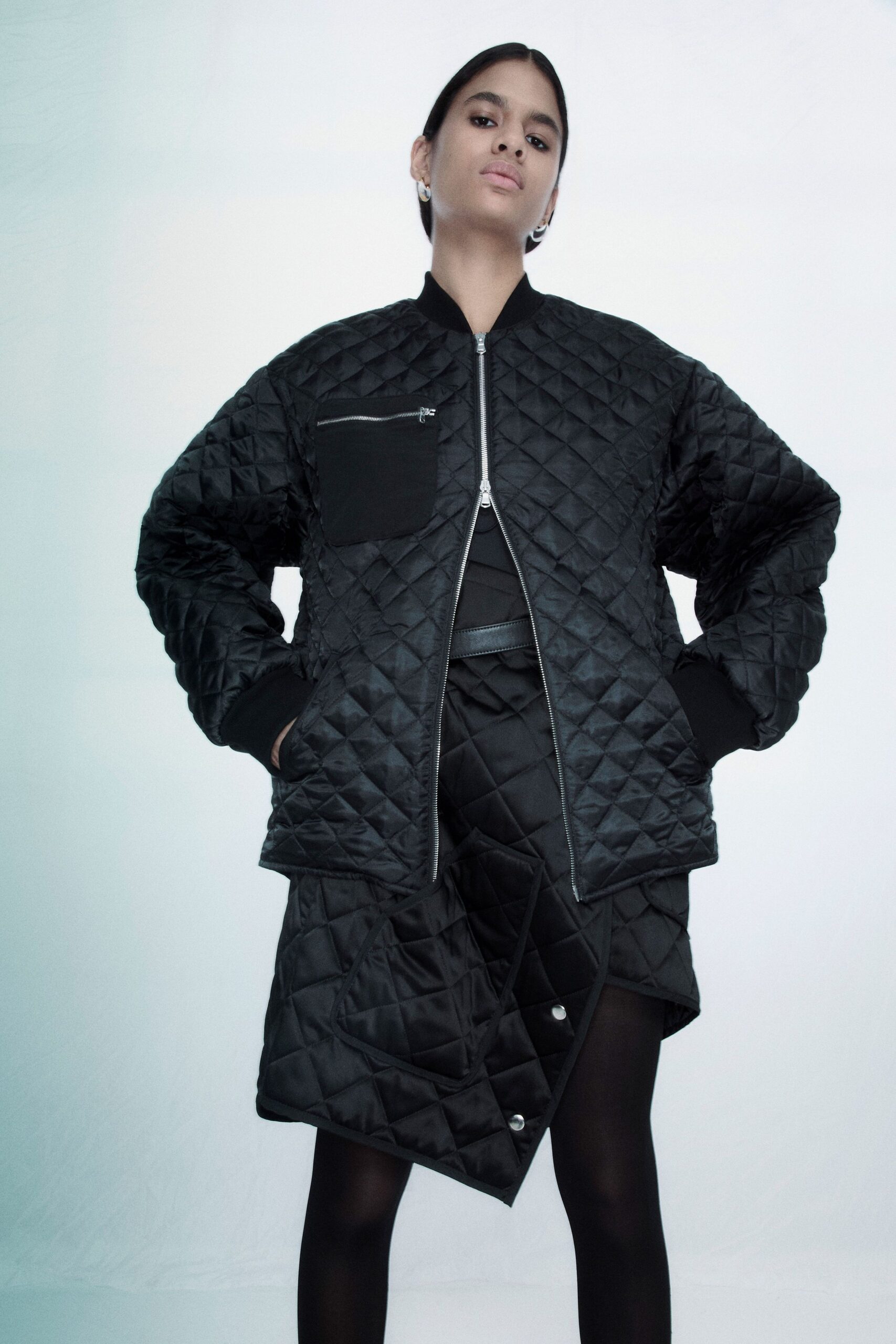 black oversized quilted jacket and fitted skirt