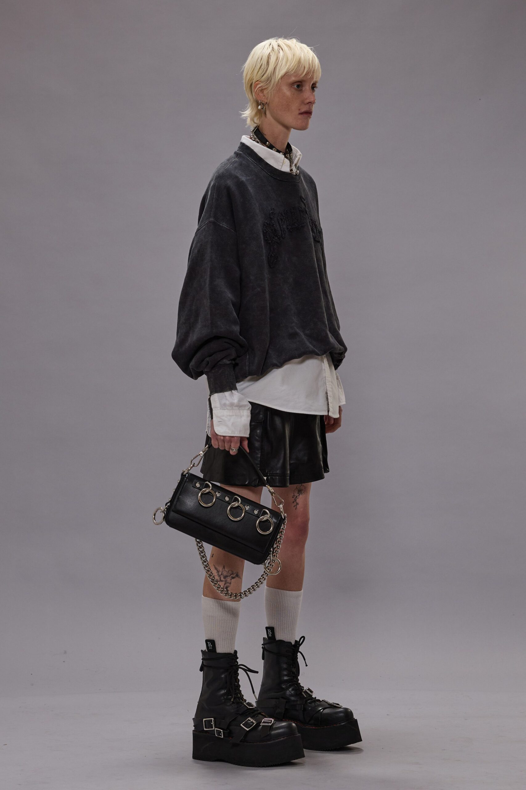 oversized black sweater with leather skirt
