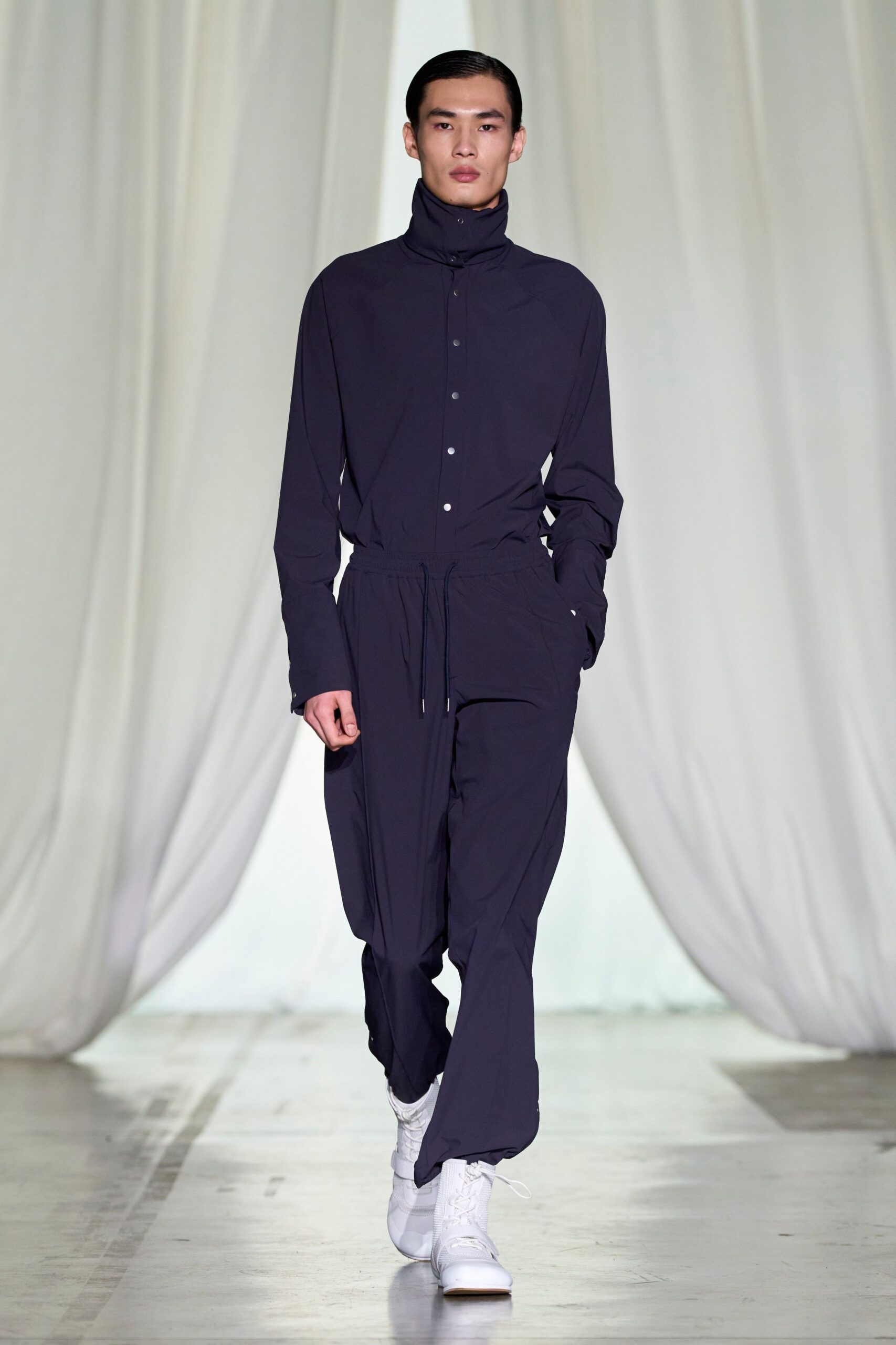 black relaxed jumpsuit with white shoes