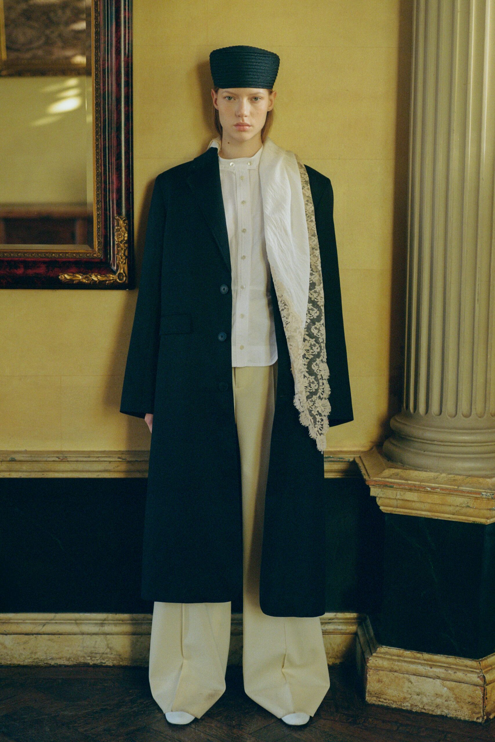 black coat white shirt beige pants