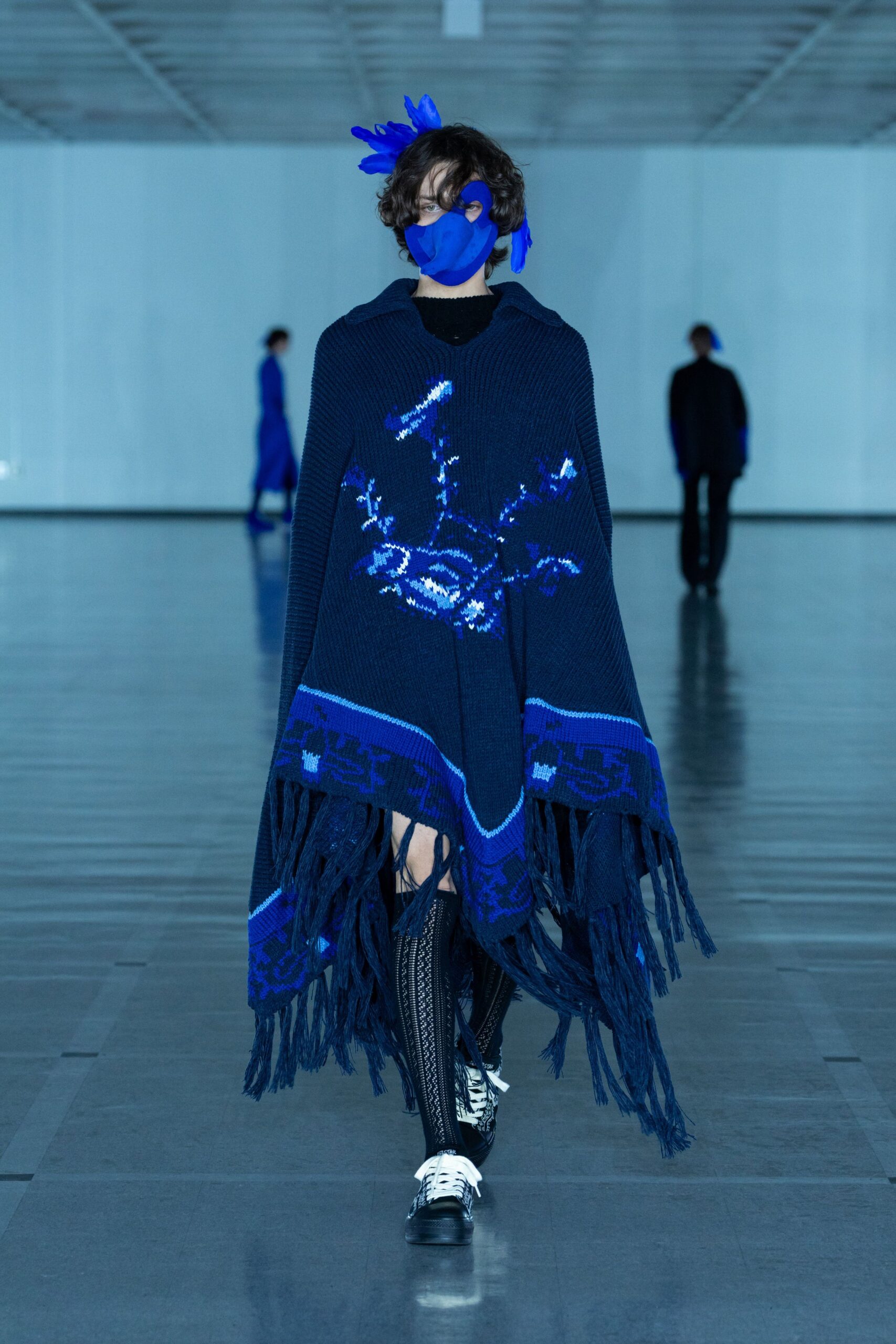 blue wool poncho with black top