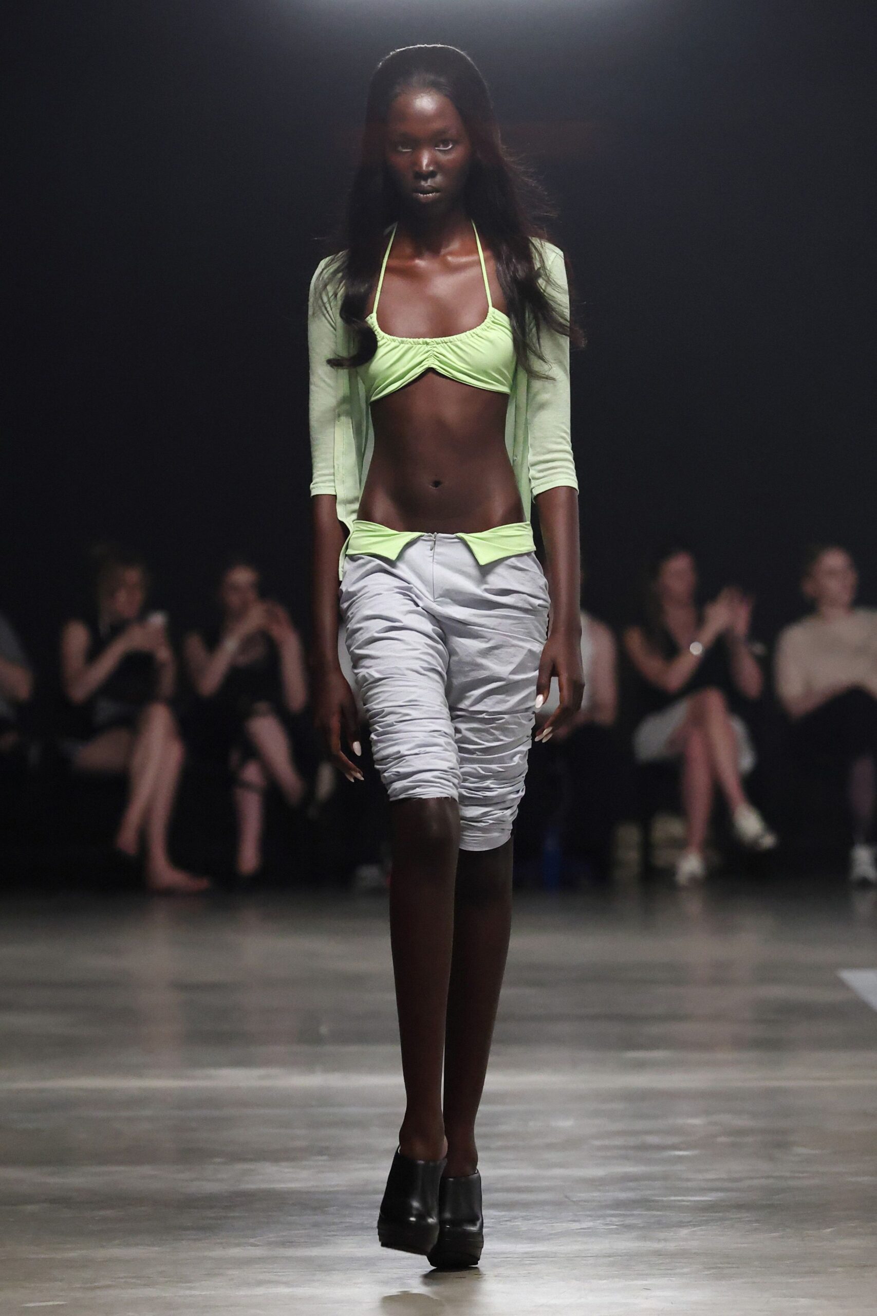 green fitted top with white shorts