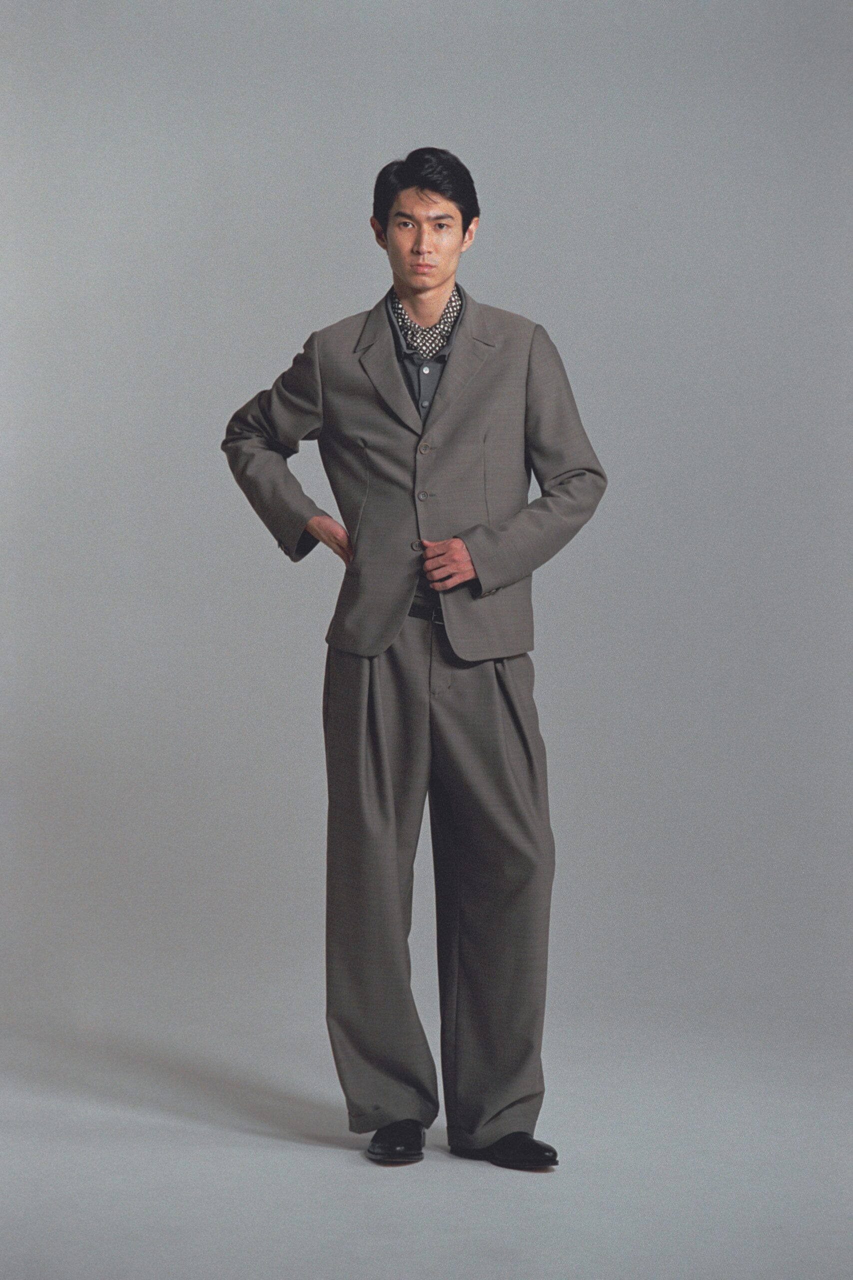 gray tailored suit with black shirt