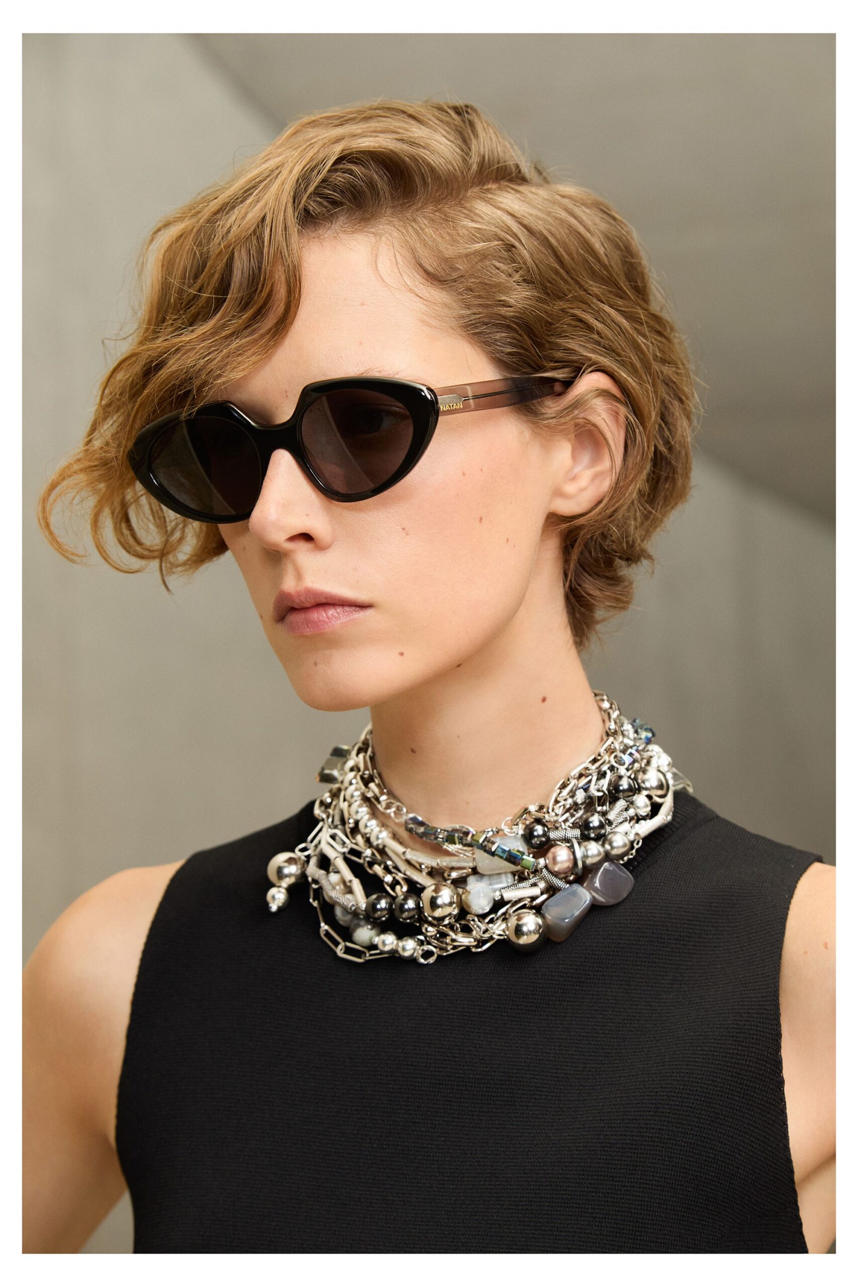 black fitted sleeveless top with sunglasses