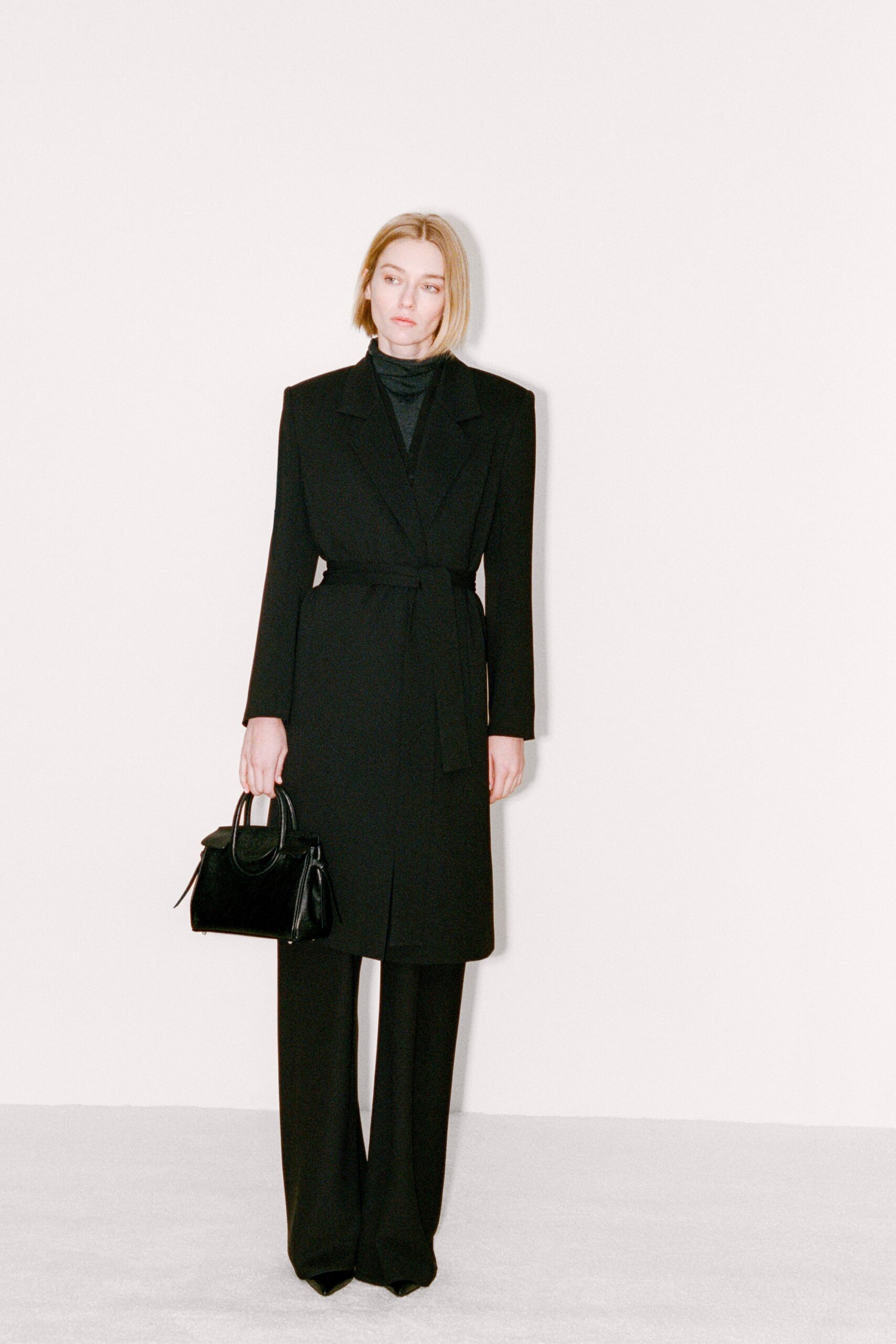 black wool long-sleeve collared tailored belted coat