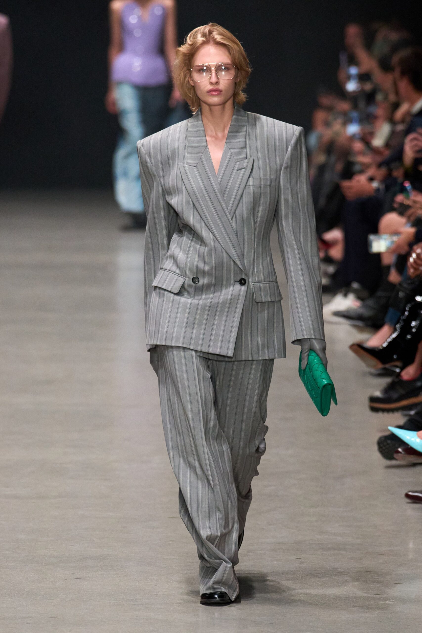 gray tailored suit with green bag