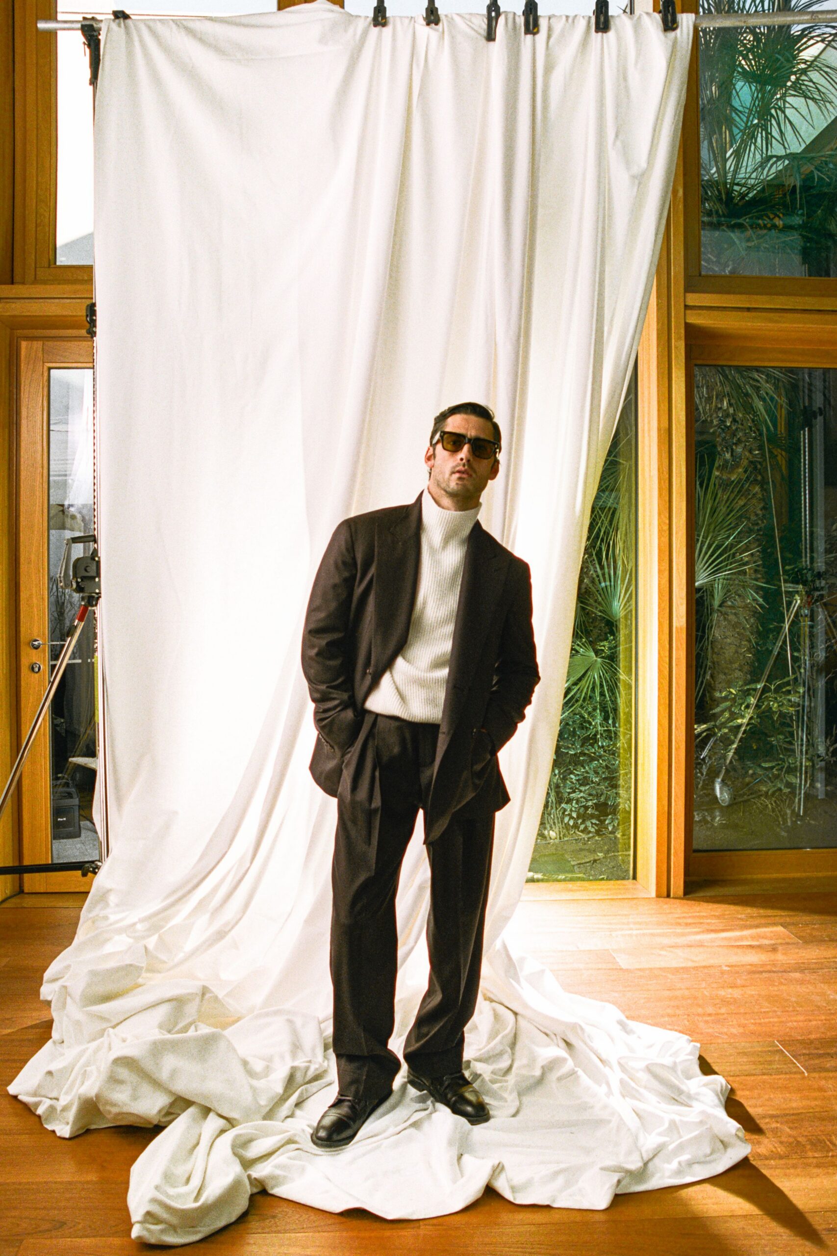 brown tailored suit with white turtleneck