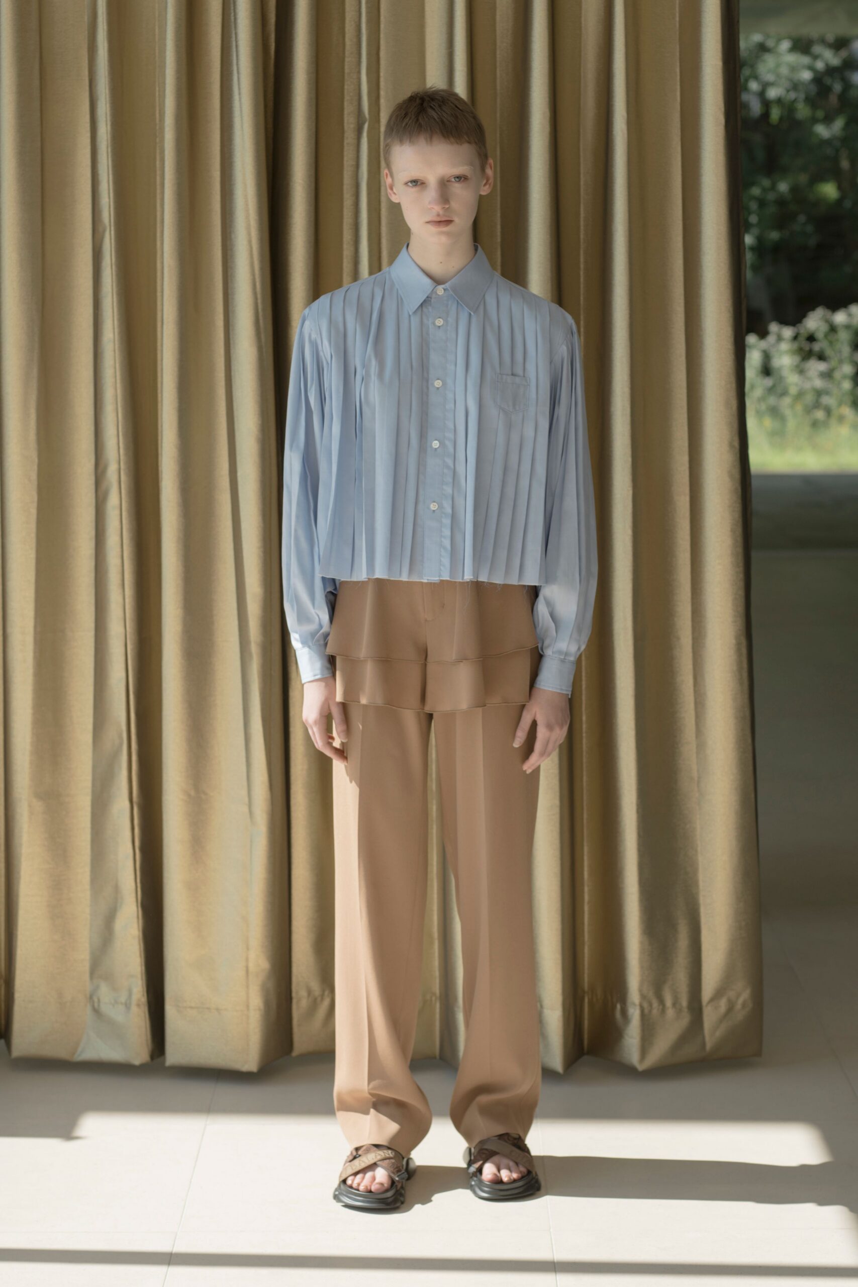 blue pleated shirt beige pants