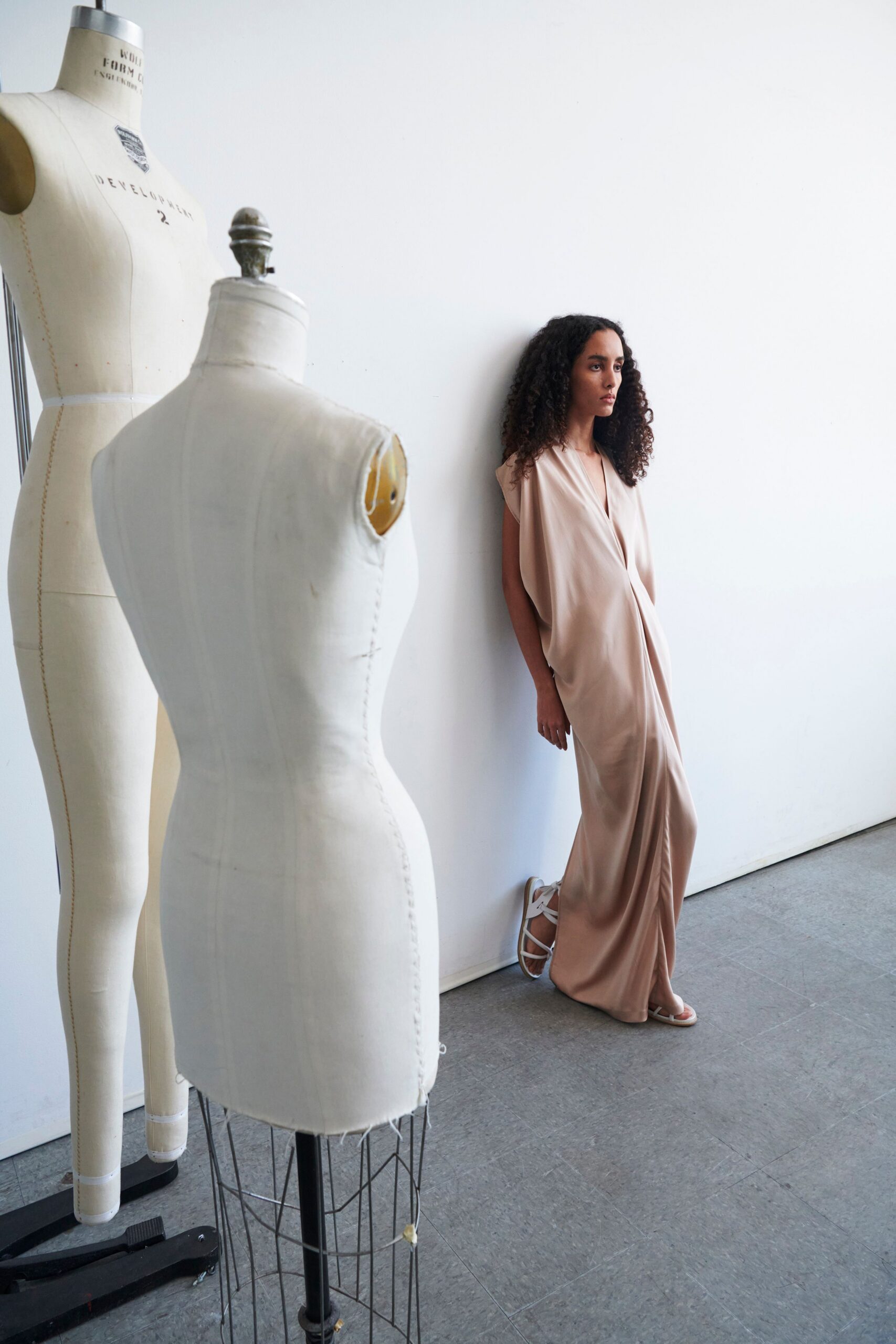 beige silk draped gown with strappy shoes