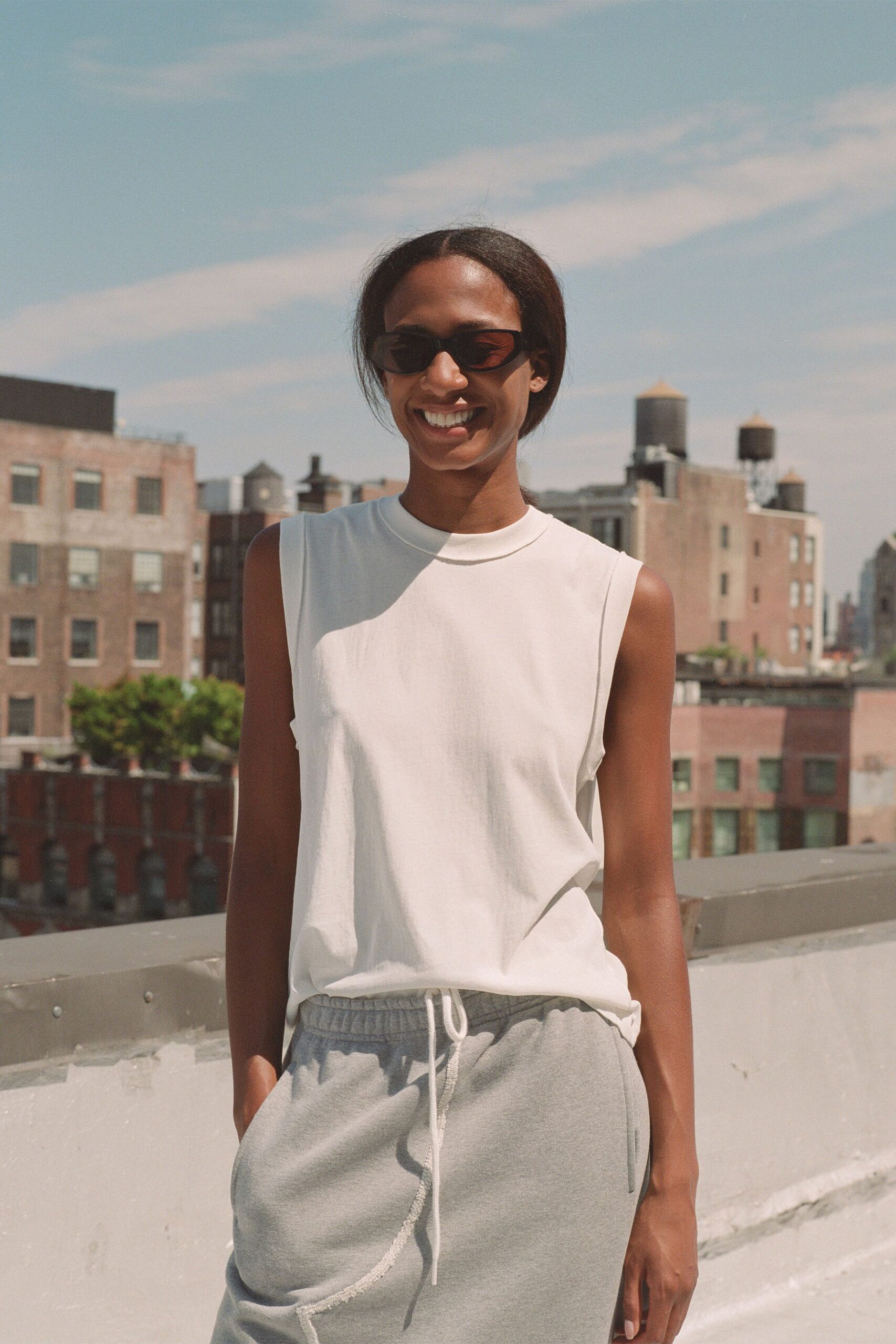 white tank-top gray pants sunglasses