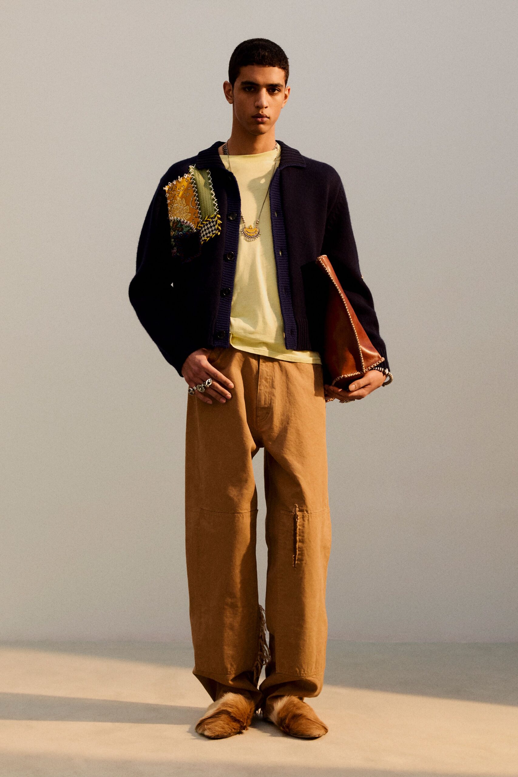 black cardigan yellow t-shirt beige pants