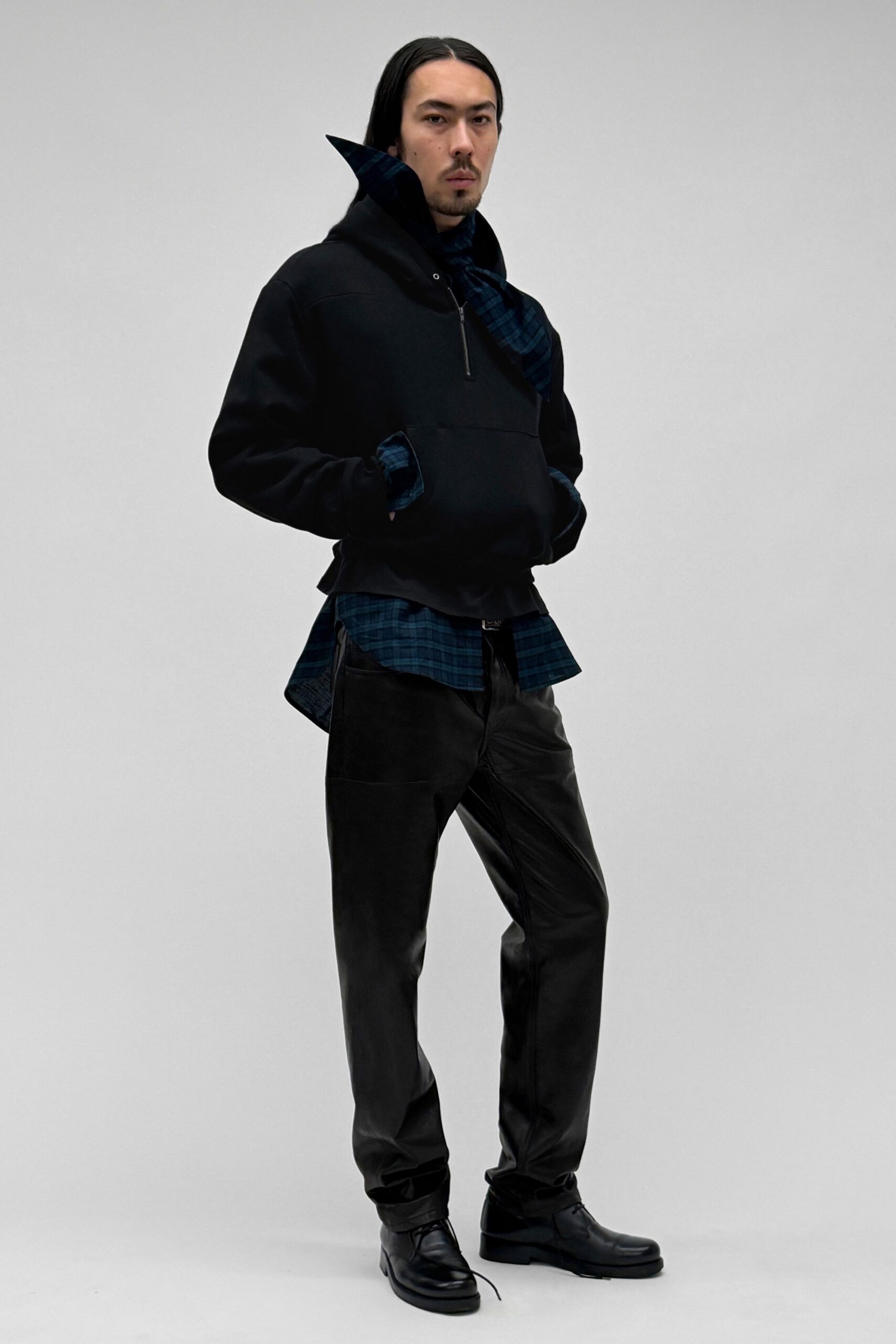 black hoodie blue checked shirt leather pants