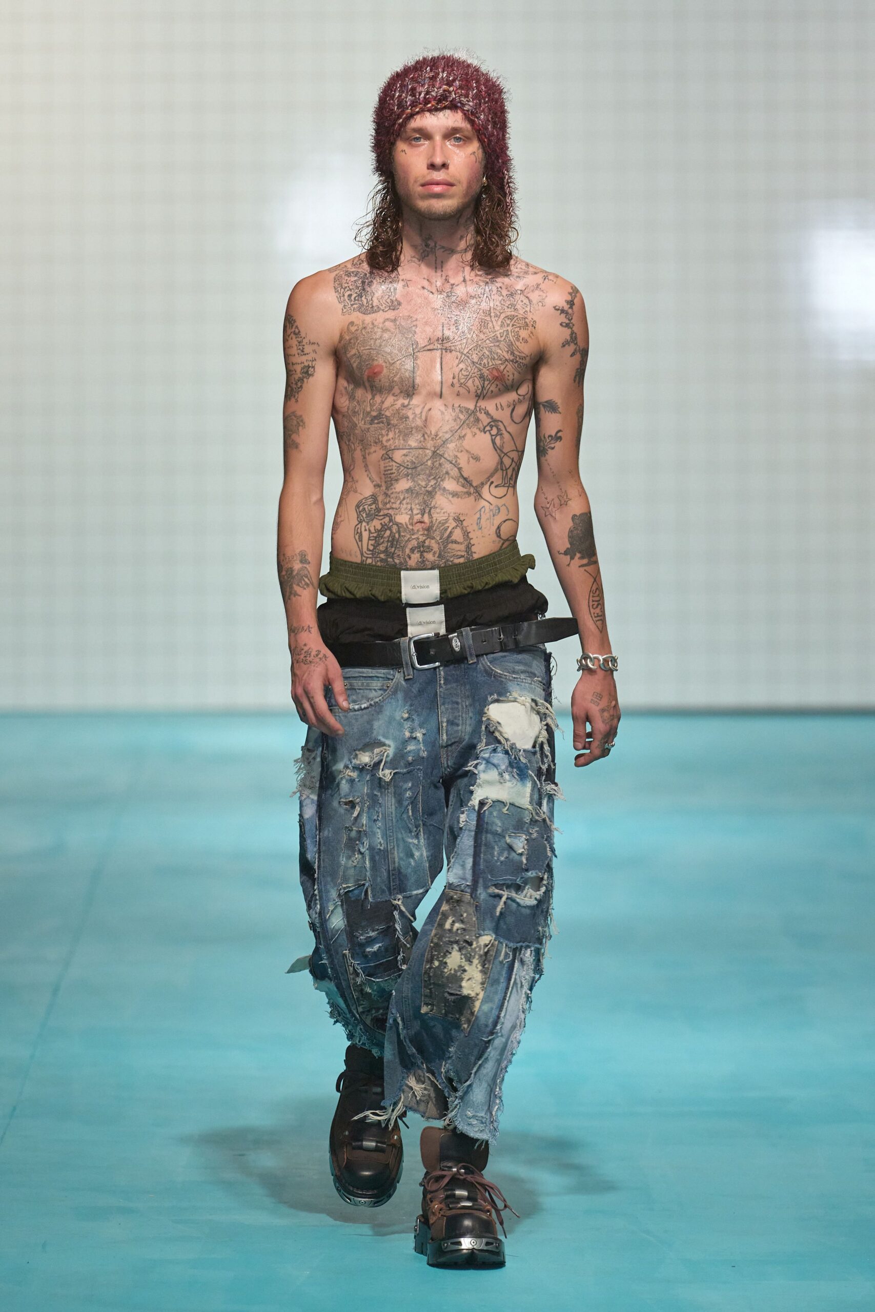 distressed denim pants with purple hat