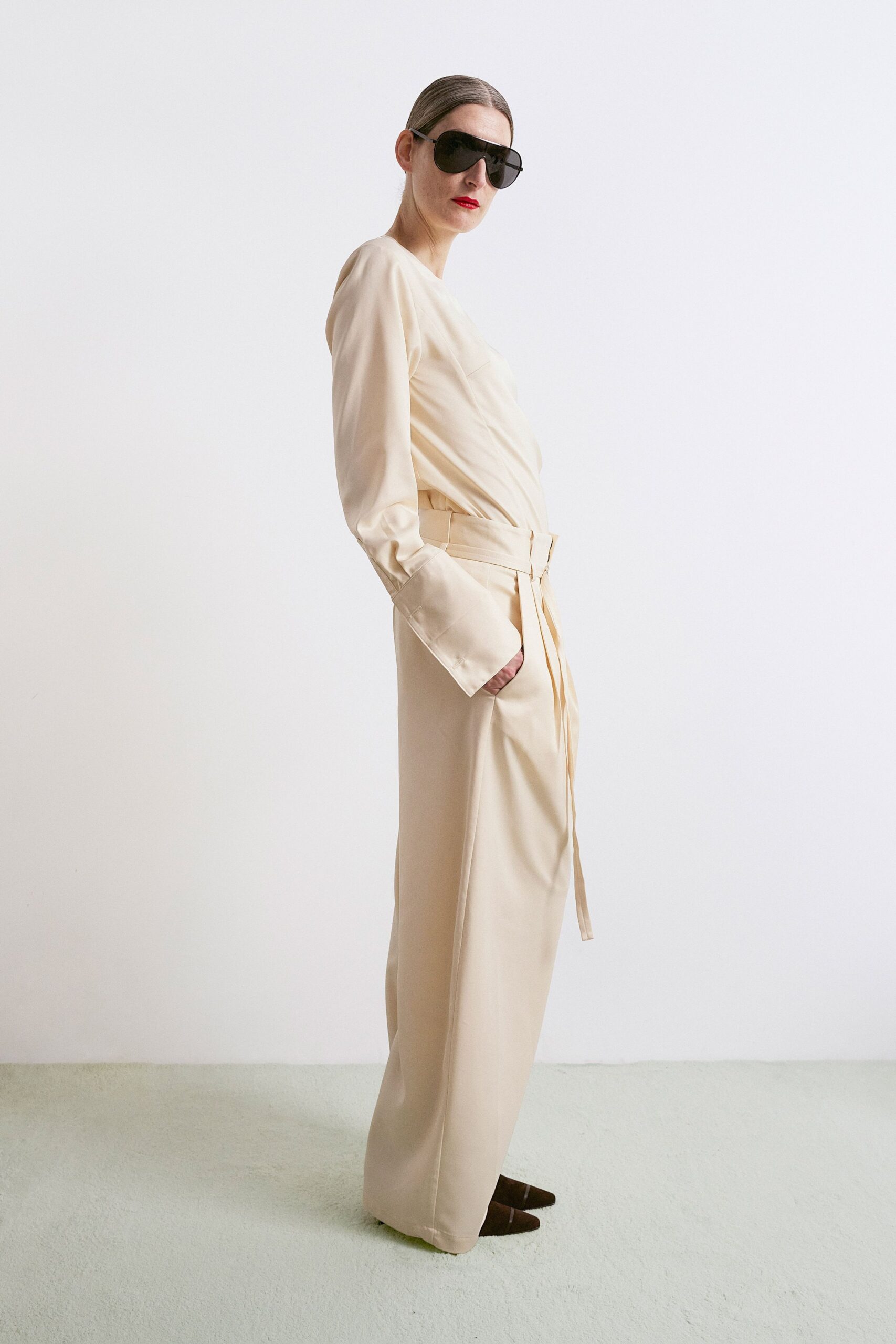 beige silk long-sleeve v-neck fitted belted draped jumpsuit