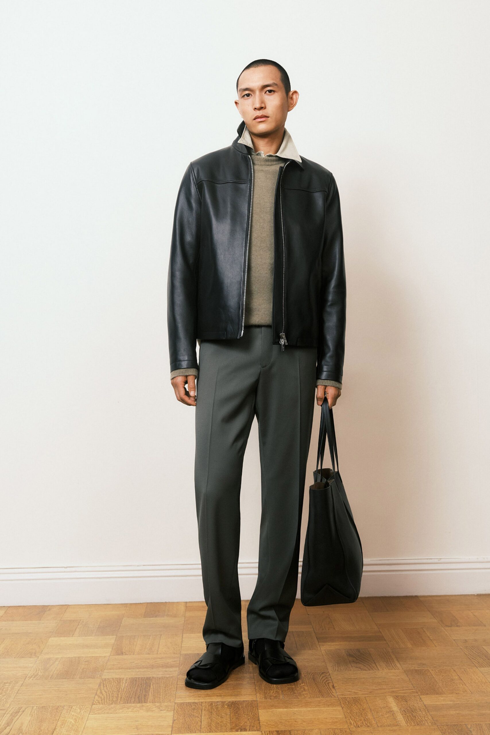 black leather jacket with gray pants