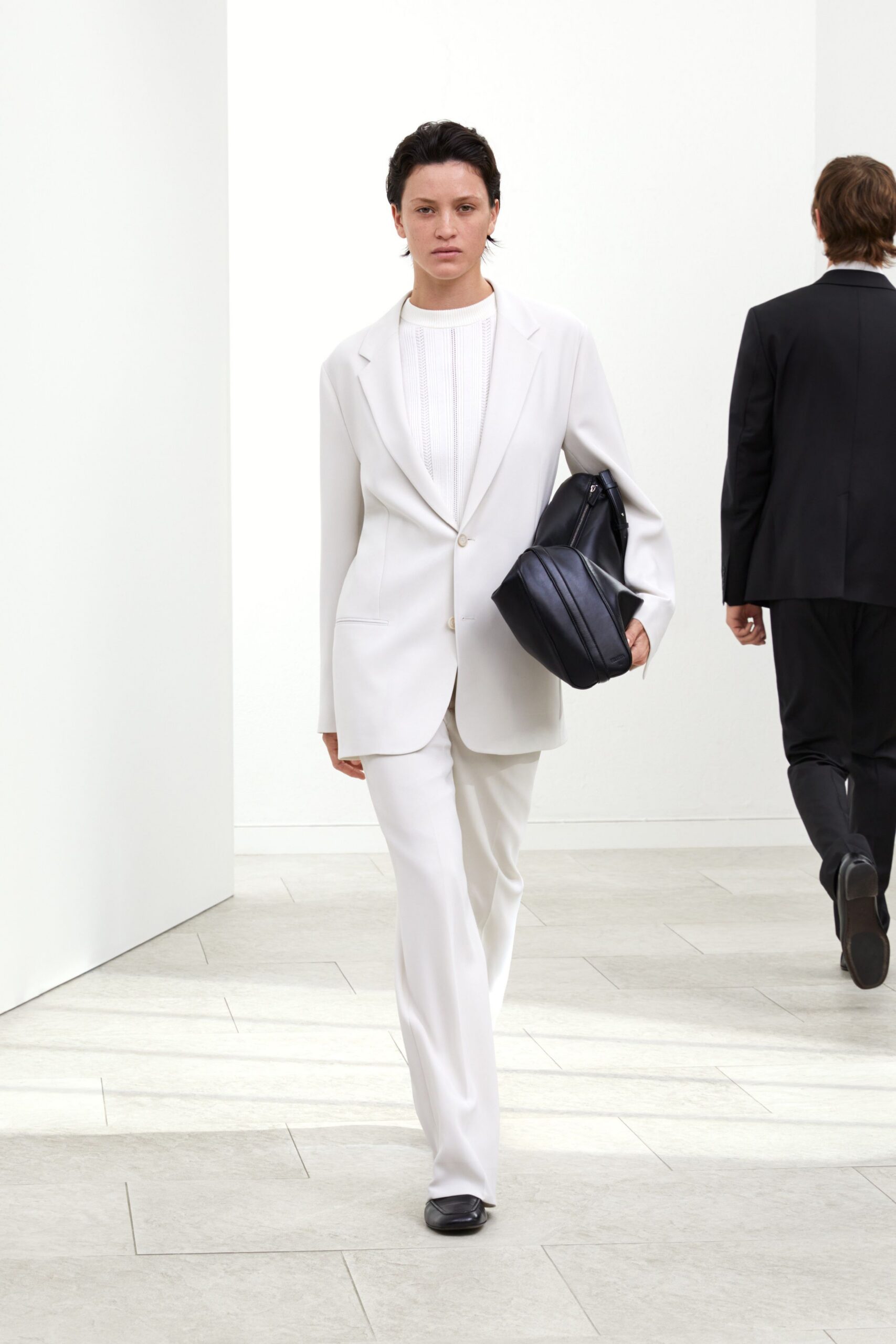 white tailored suit with black bag