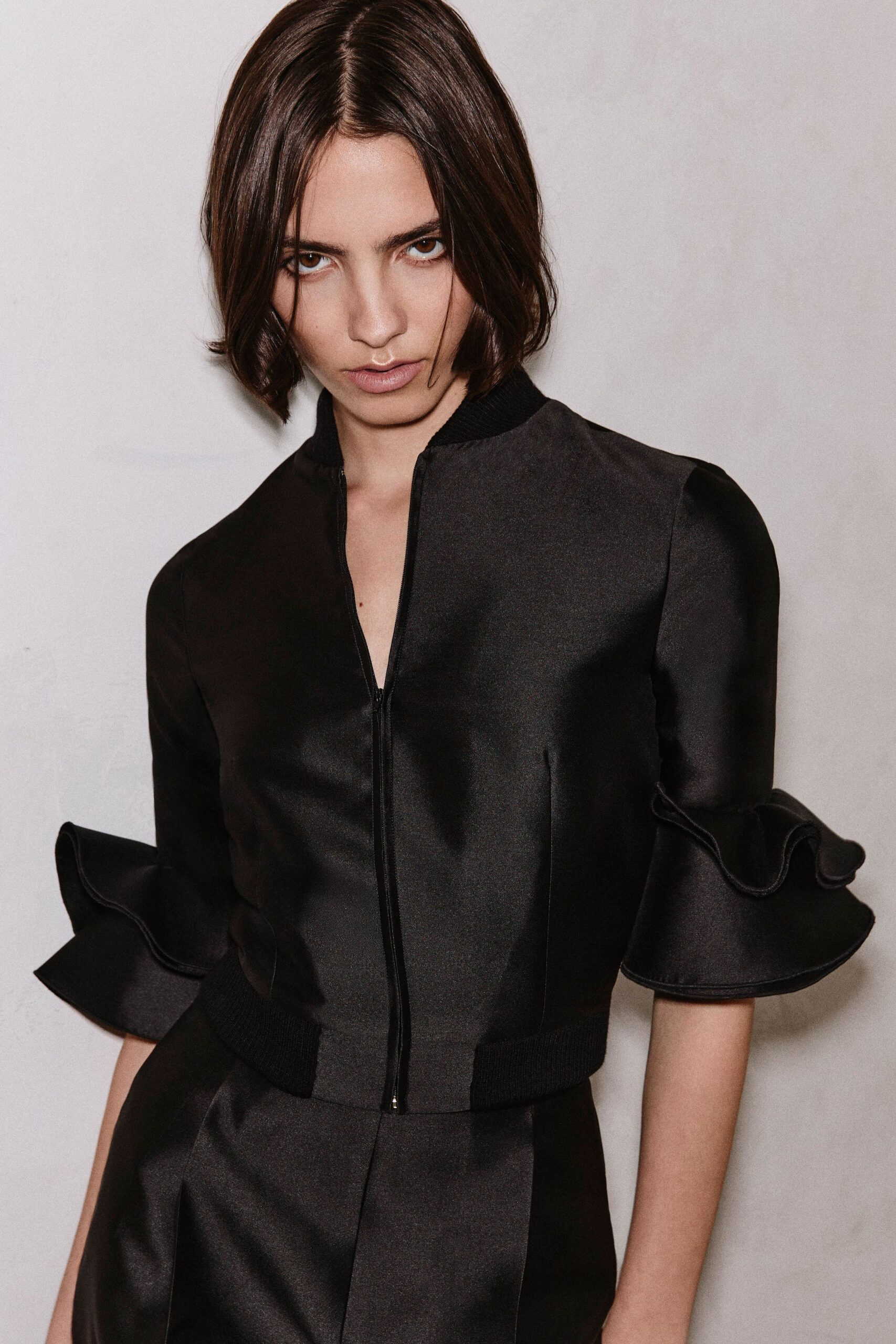 black satin short-sleeve collared fitted ruffled jacket