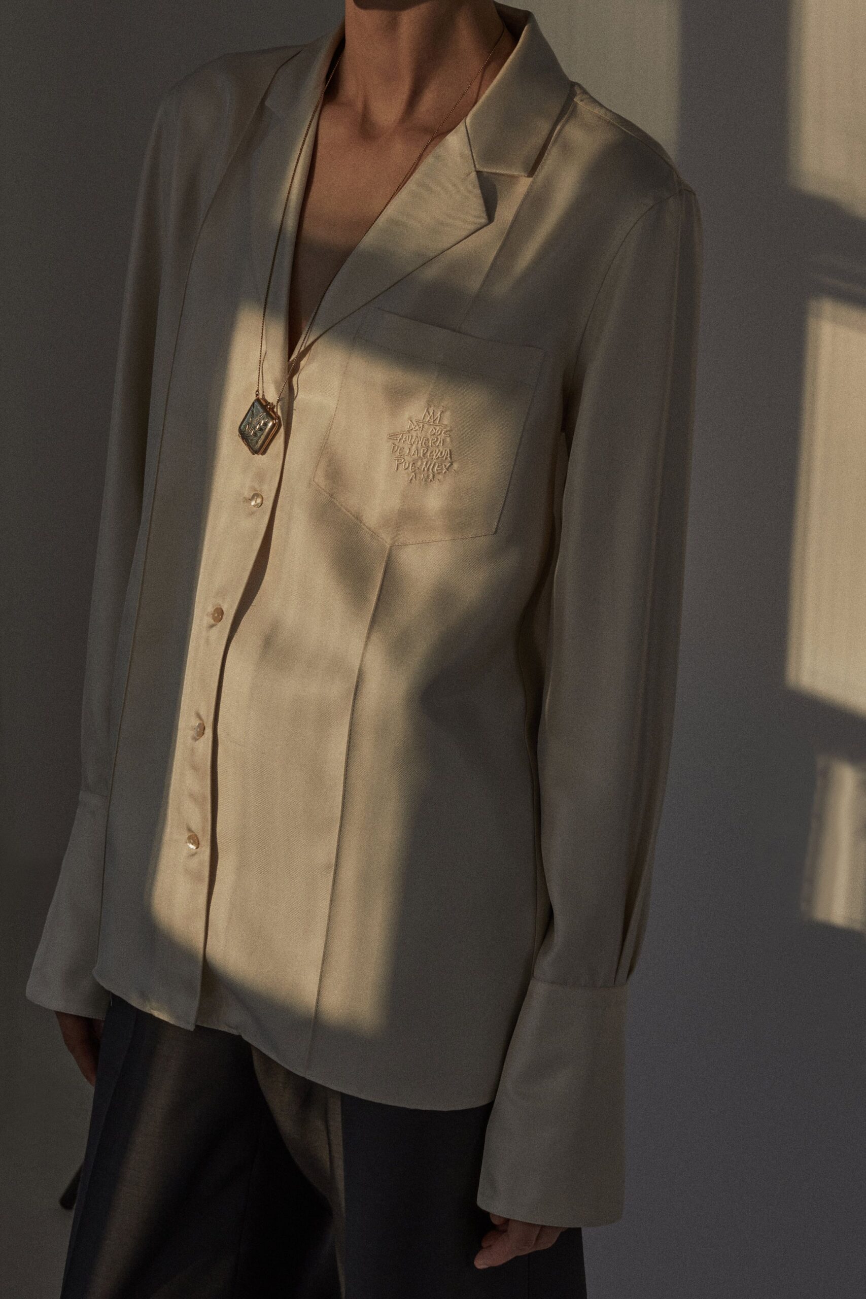 beige silk shirt with black pants