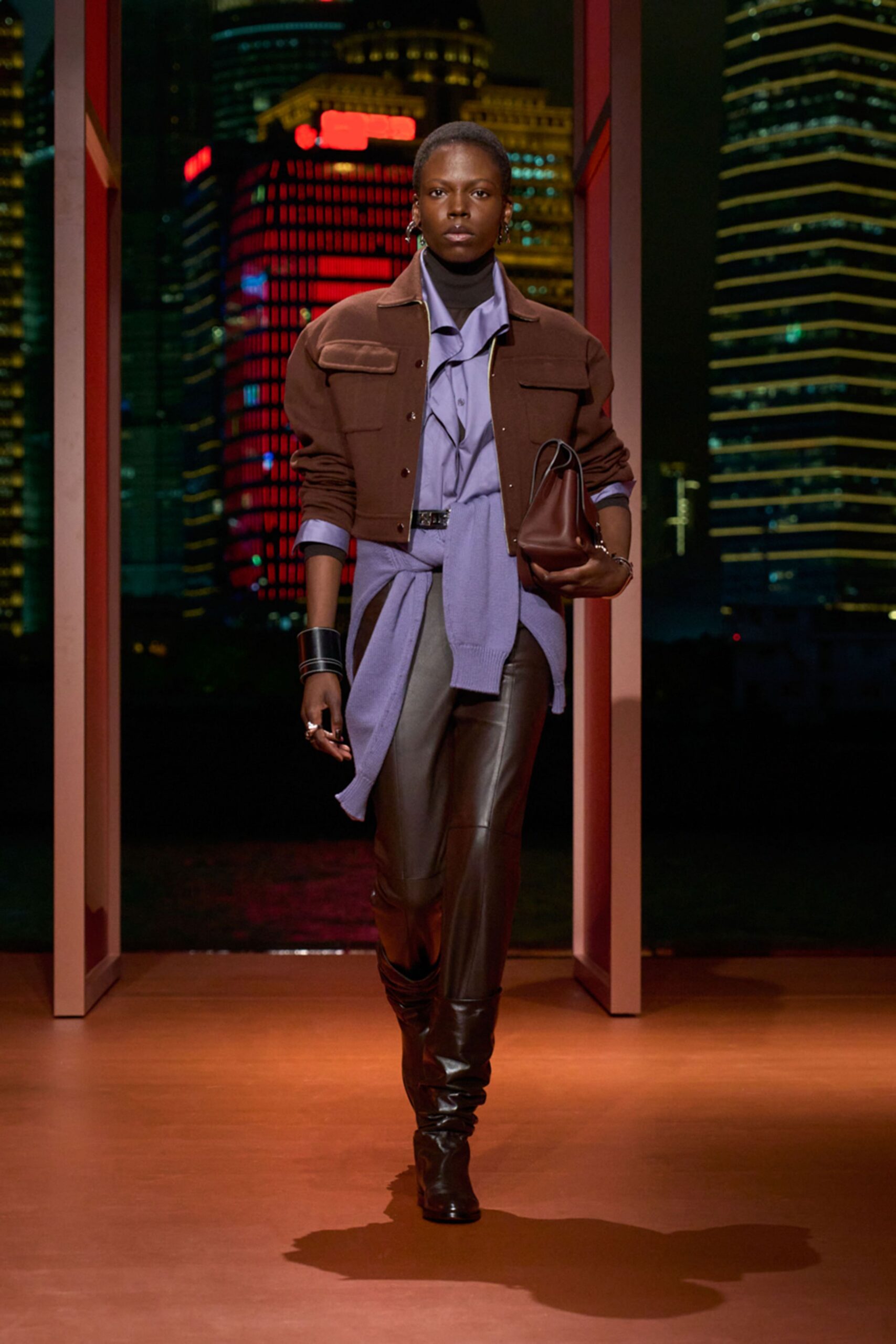 brown jacket blue shirt black pants
