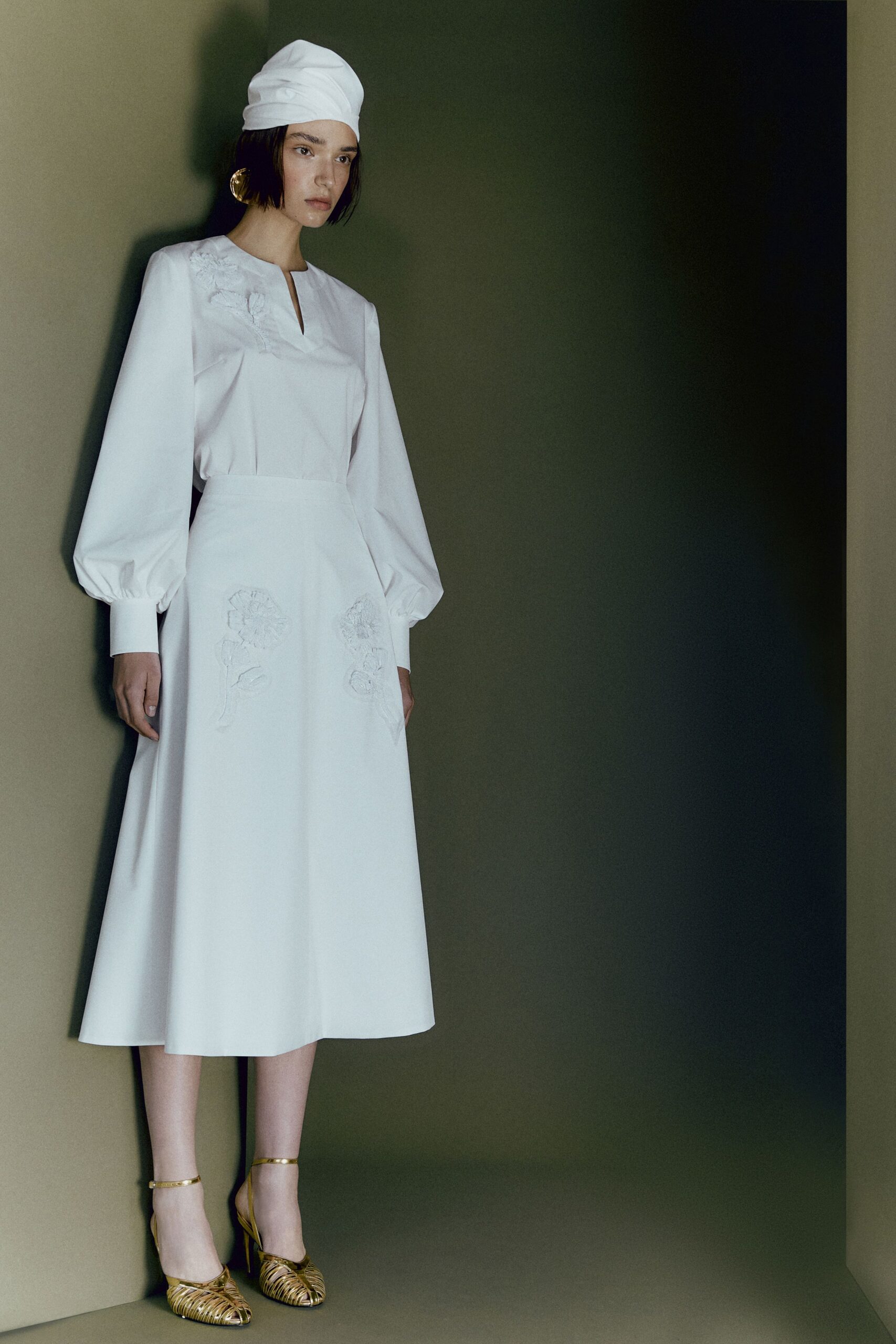 white midi dress with gold shoes