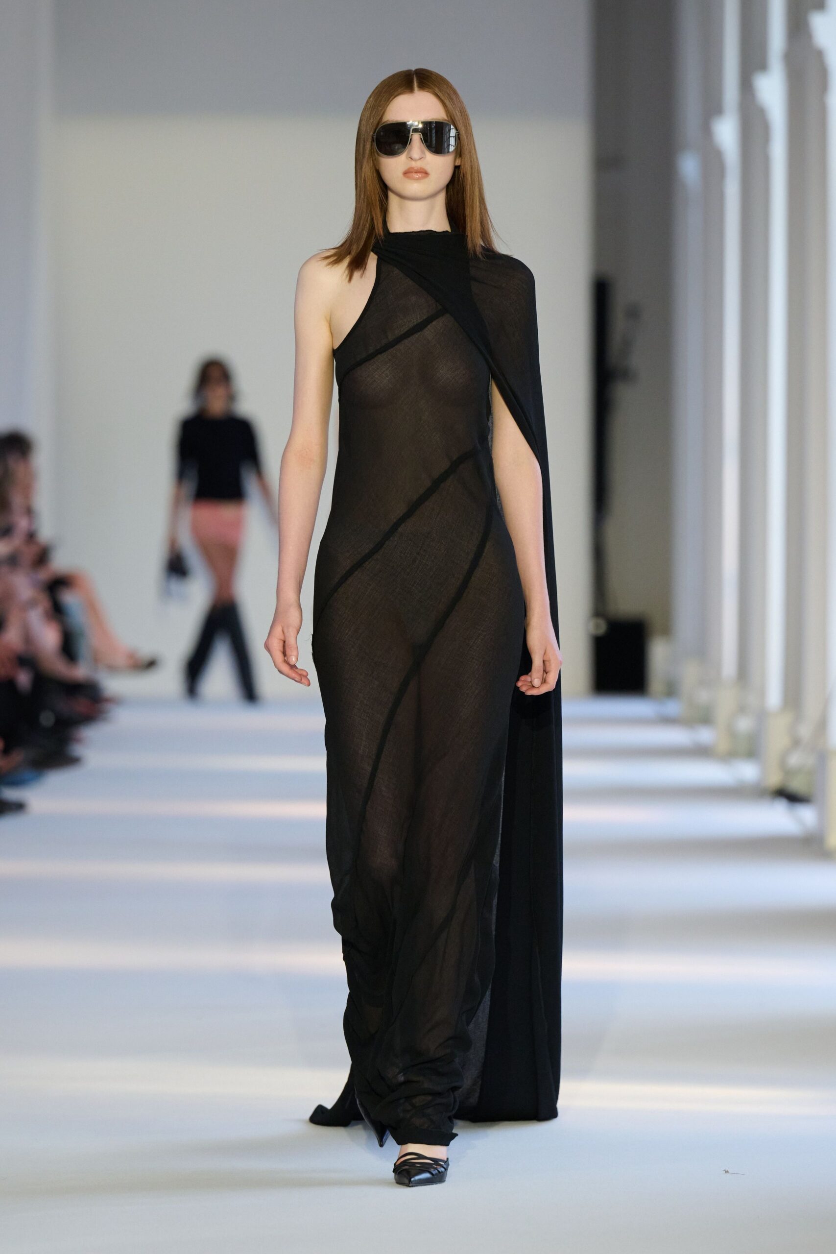 black sheer asymmetric gown with sunglasses