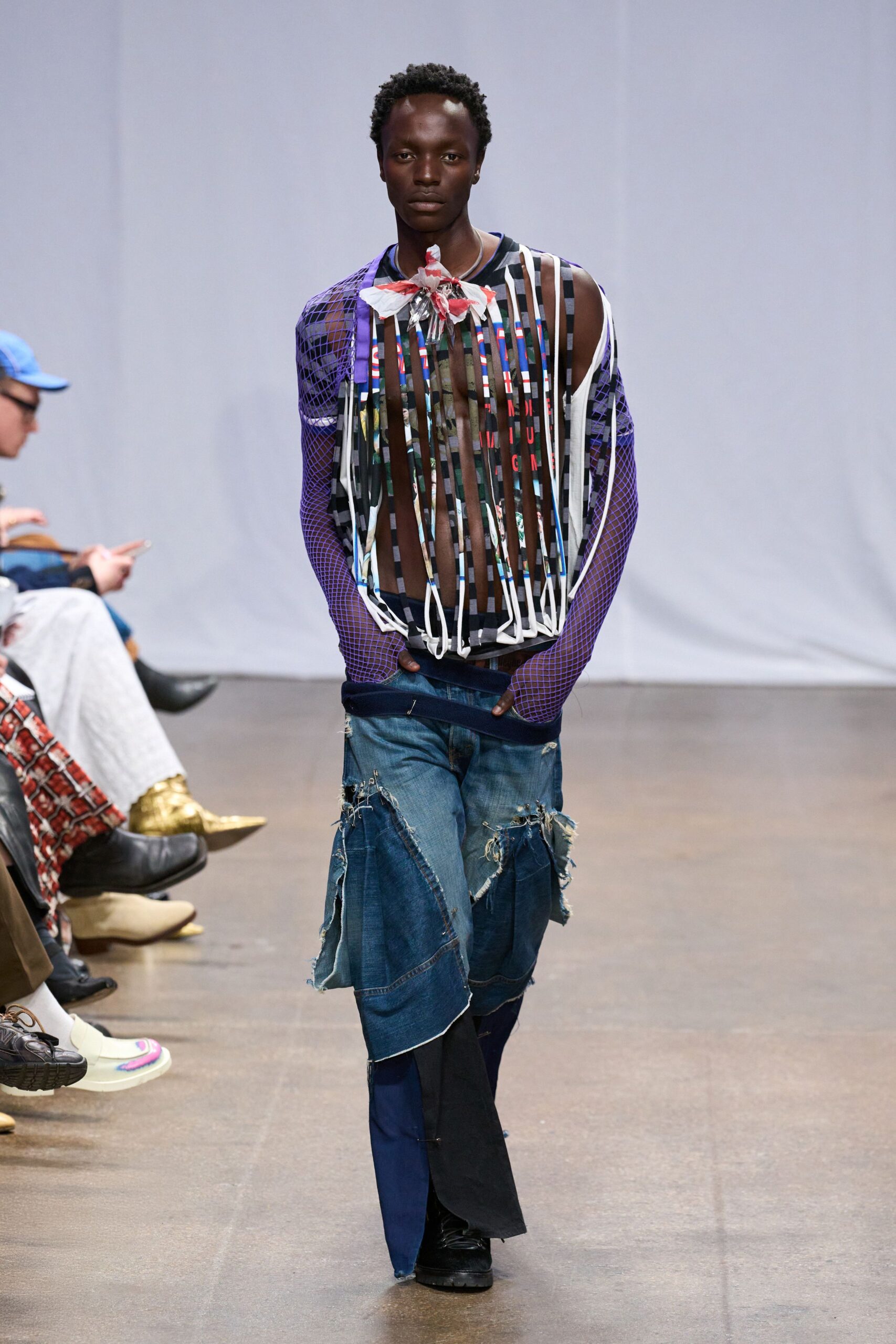 purple fringed top with distressed jeans