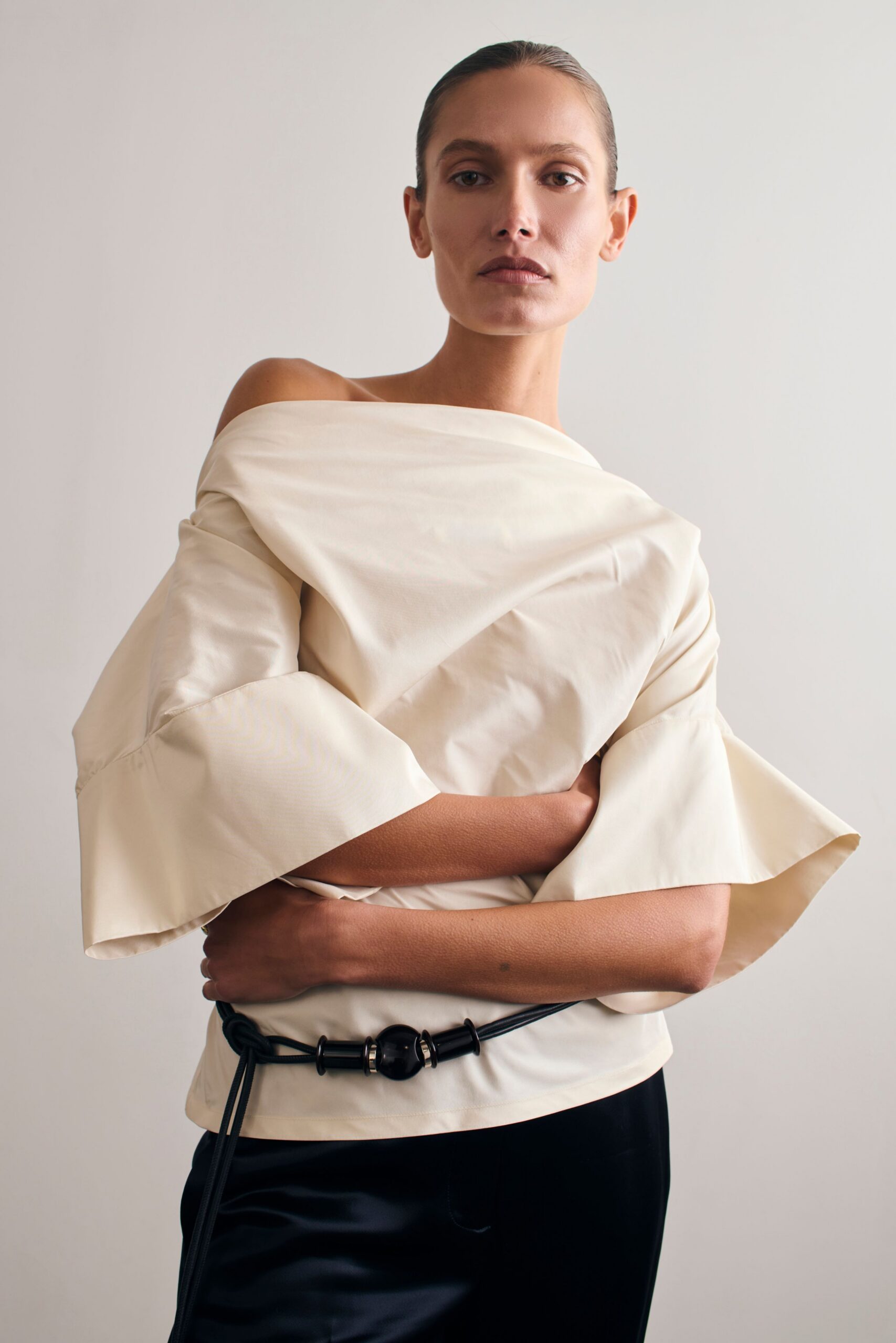 white off-shoulder top with black pants
