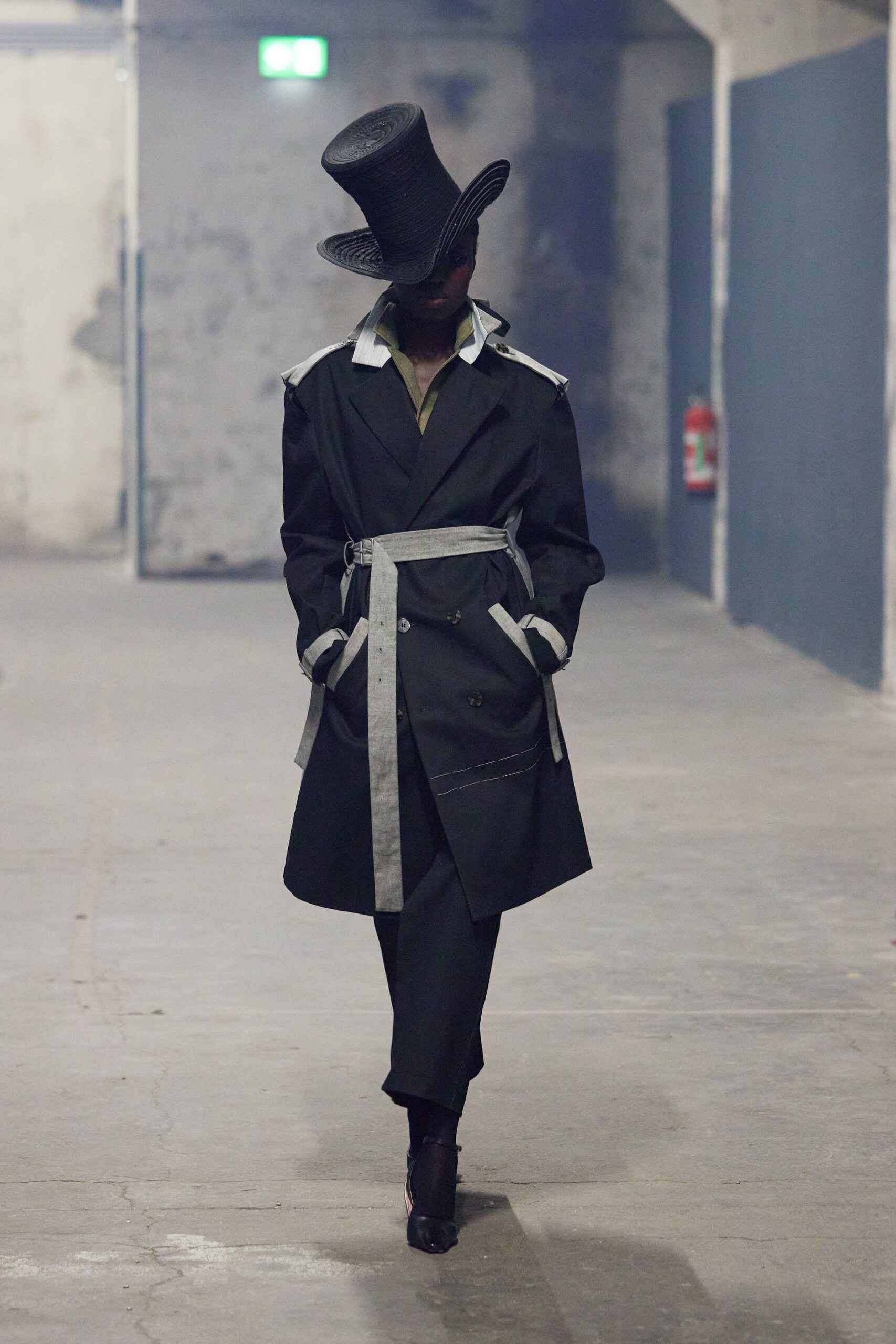 black trench coat and pants with hat