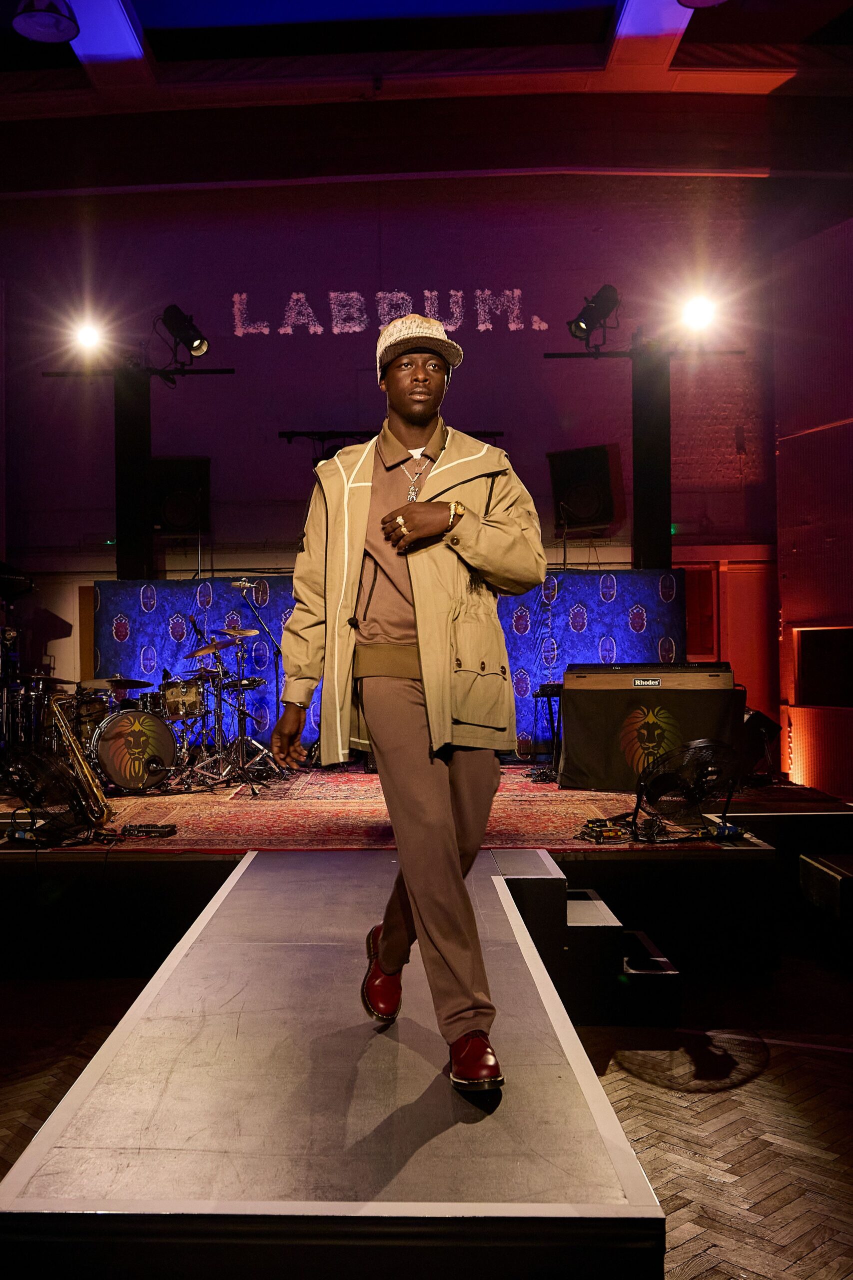 beige coat brown pants red shoes
