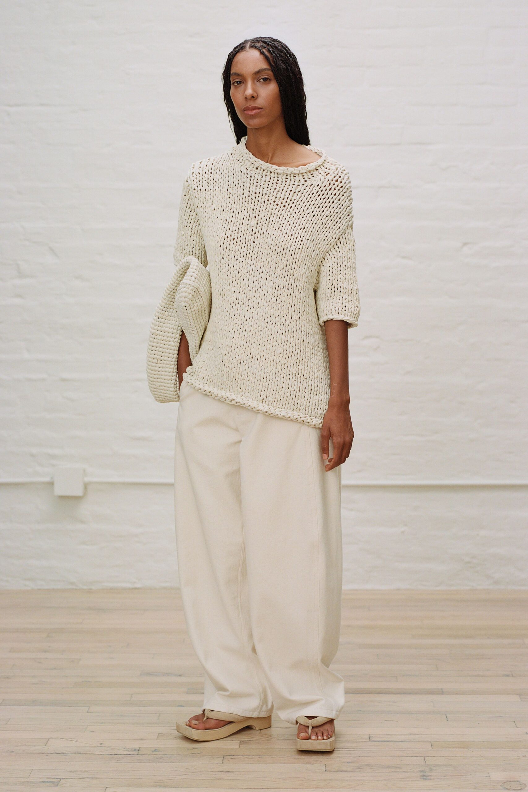 white knit top with beige pants