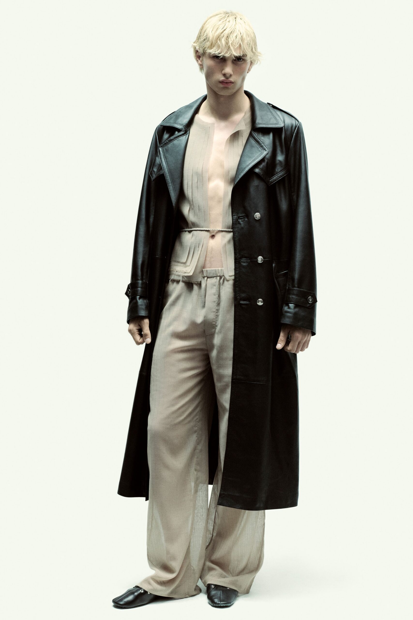 black leather coat with beige pants