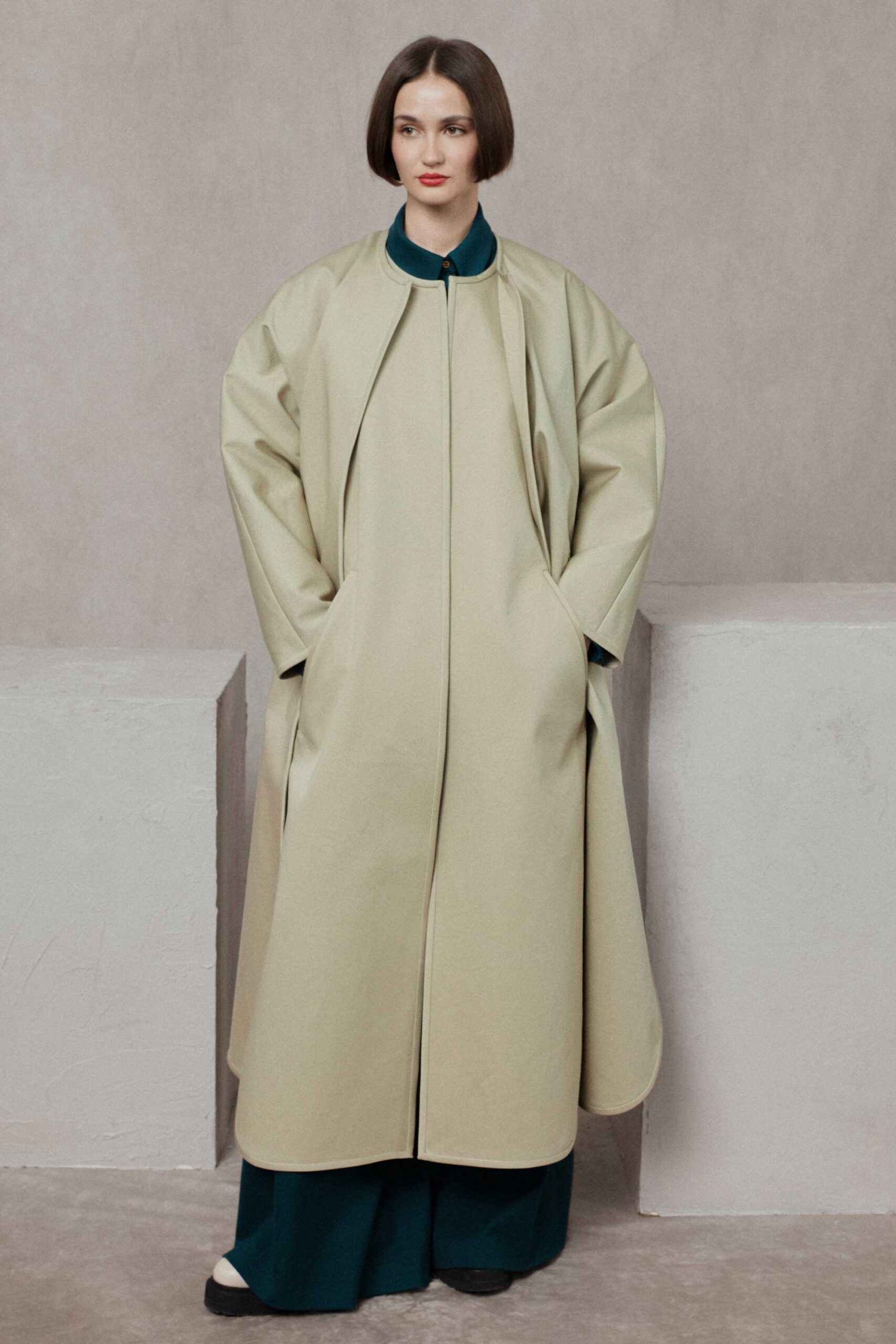 beige relaxed coat with green pants