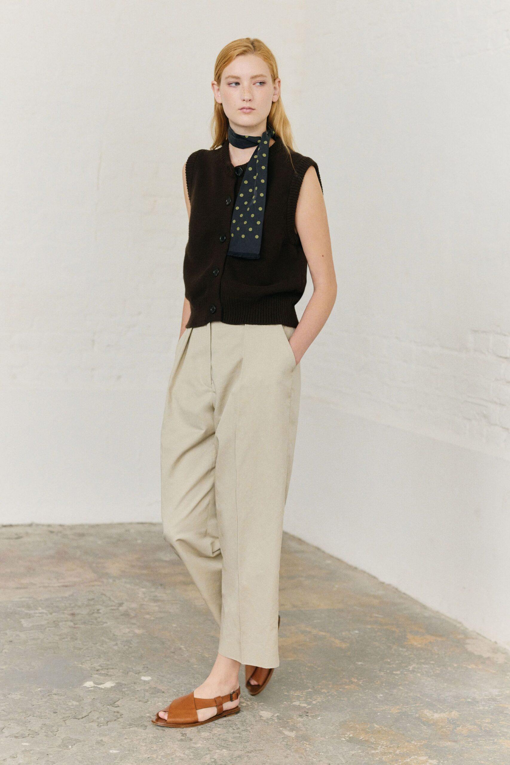 black vest beige pants brown shoes