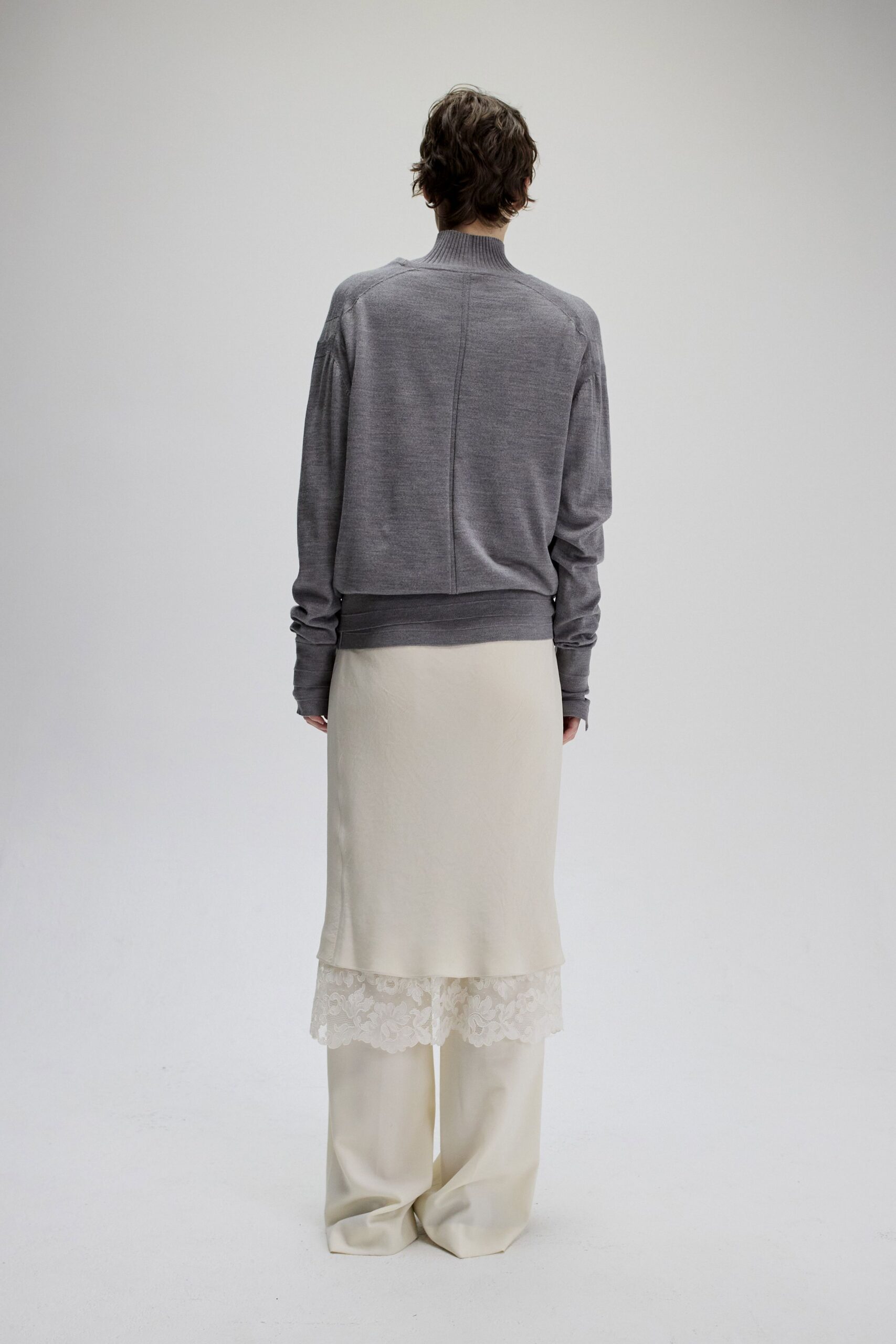 gray sweater white layered skirt beige pants