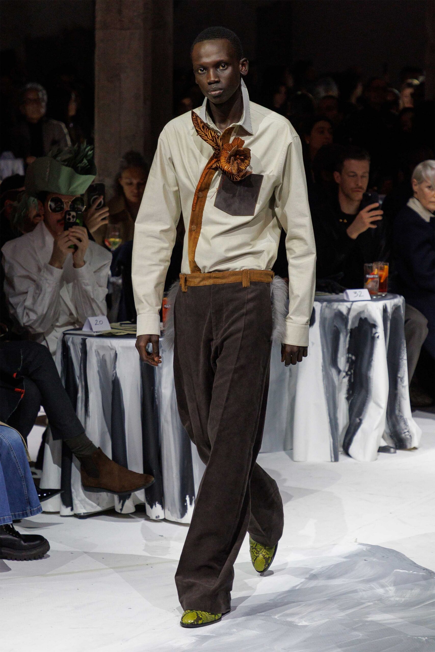 beige shirt brown pants green shoes