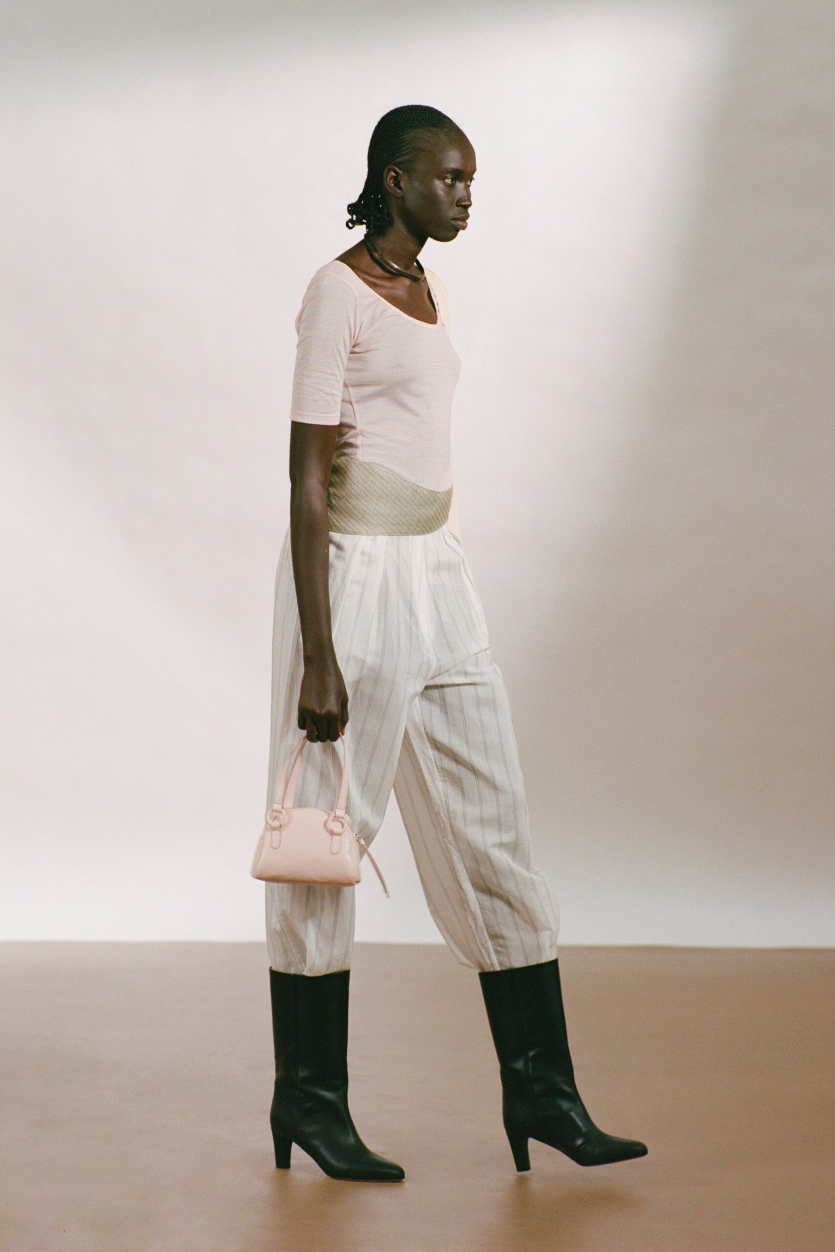 pink fitted top with striped pants
