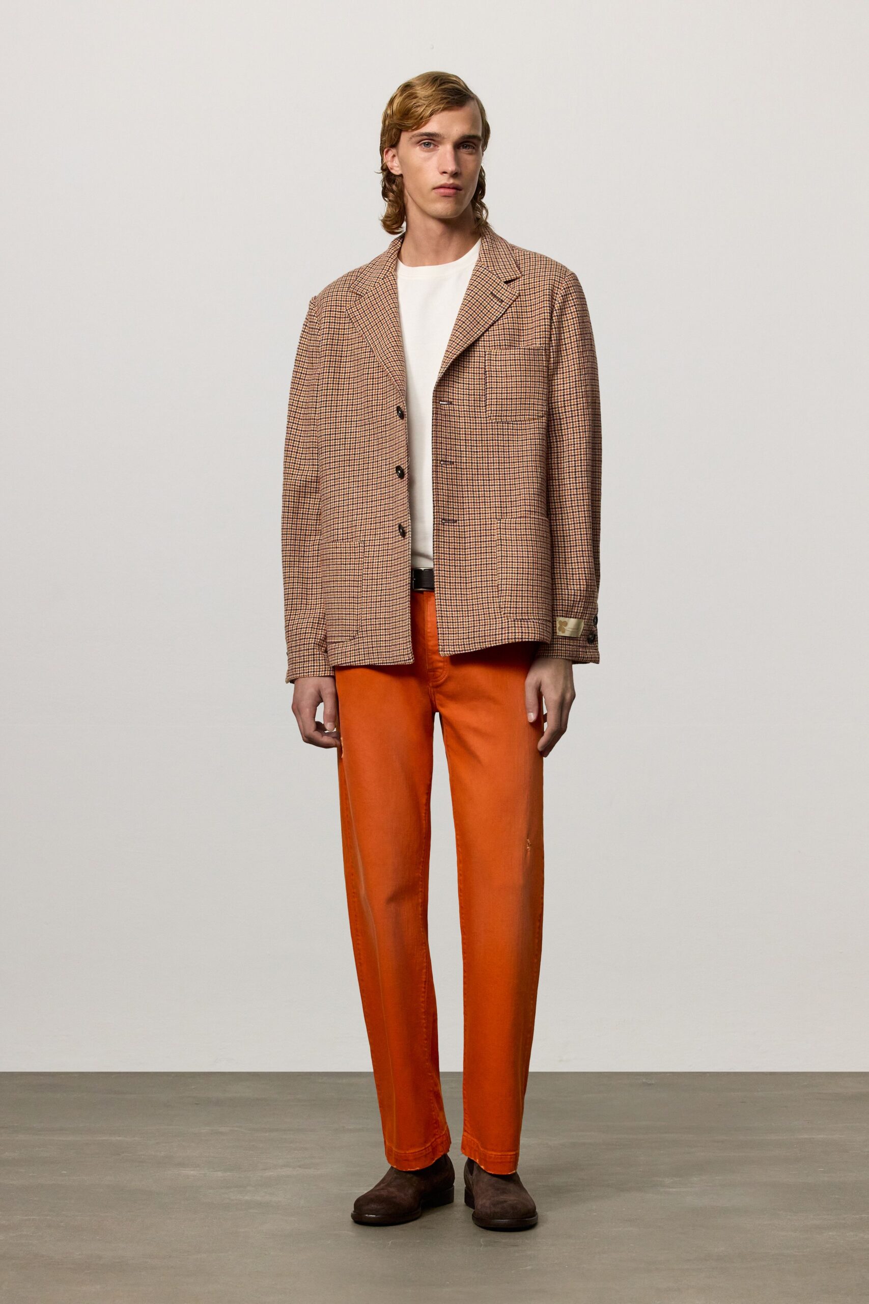 brown checked jacket with orange pants