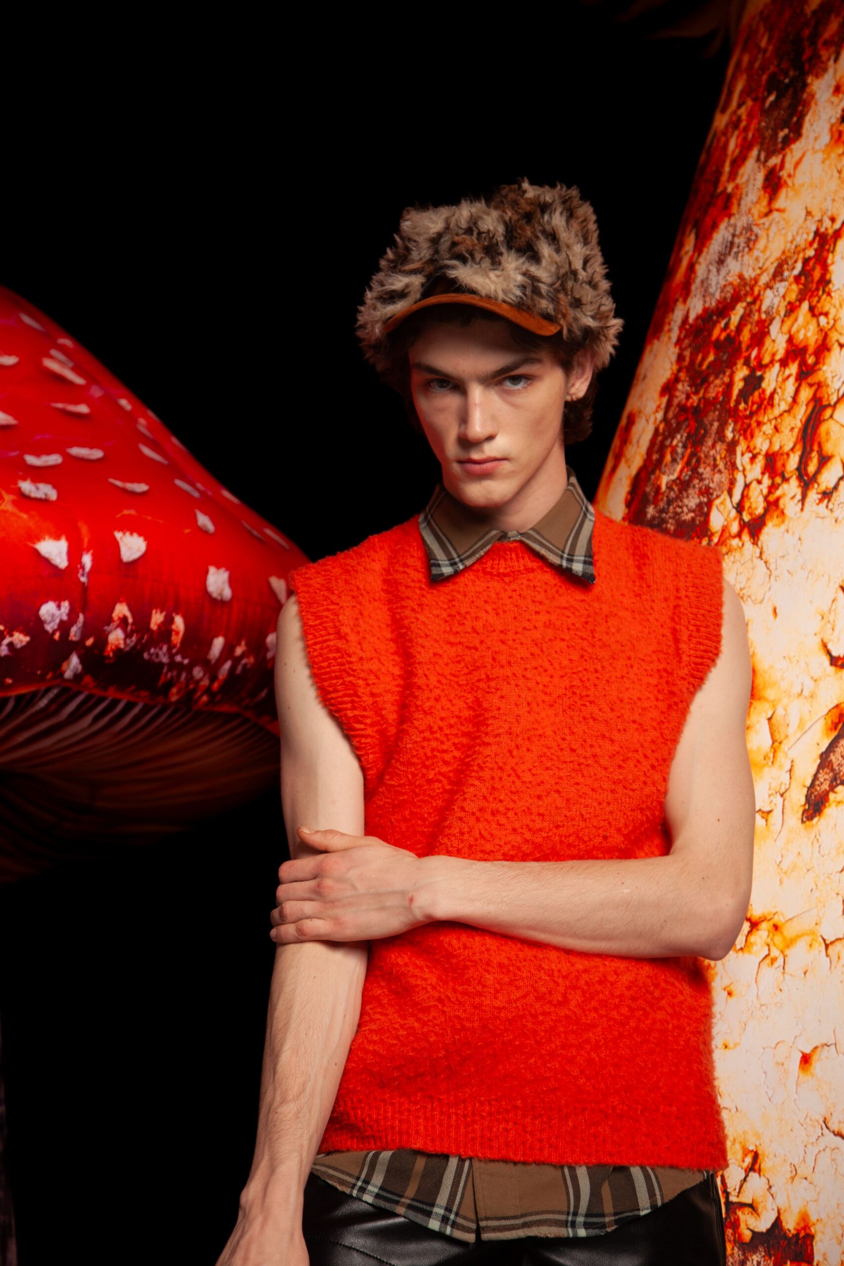 orange sleeveless sweater with brown shirt