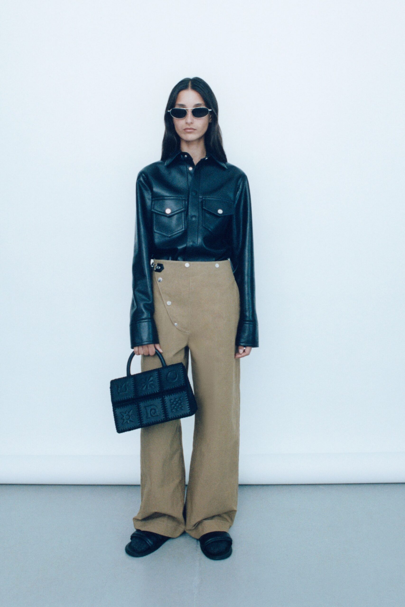 black leather shirt beige pants